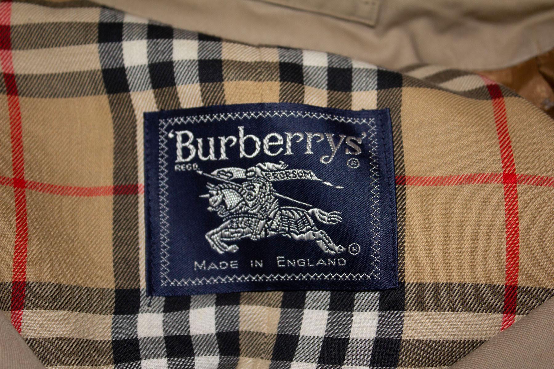 A chic and useful vintage coat by Burberry. In the classic taupe with check lining, the coat has two internal pockets and  a back vent. 
Measurements: Bust up to 49'', length 42''