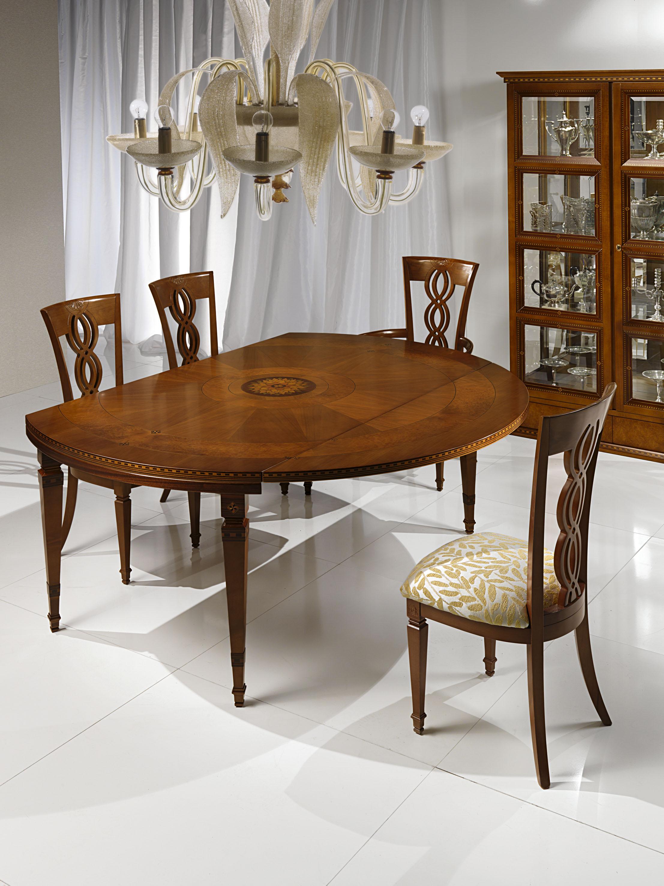 This table has a solid wood structure with inlaid central rosette. When the table is closed, the top has an oval shape; when the half-moons are overturned, a large round top is obtained.