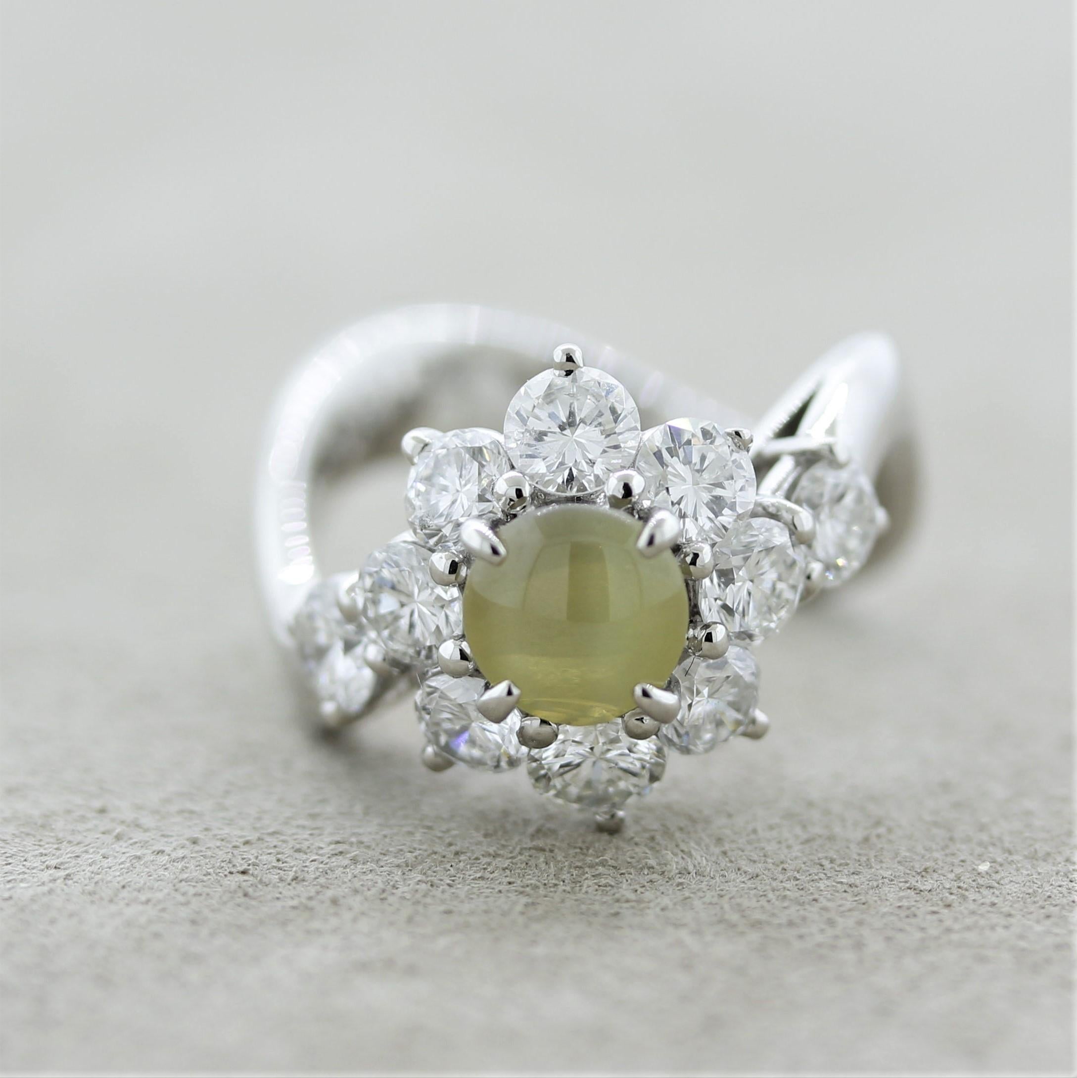A beautiful cats eye chrysoberyl takes center stage of this platinum made ring. It has an extra fine eye as well as the classic “milk & honey” color which is so hard to find (it weighs 1.74 carats). It is complemented by 2.00 carats of large round
