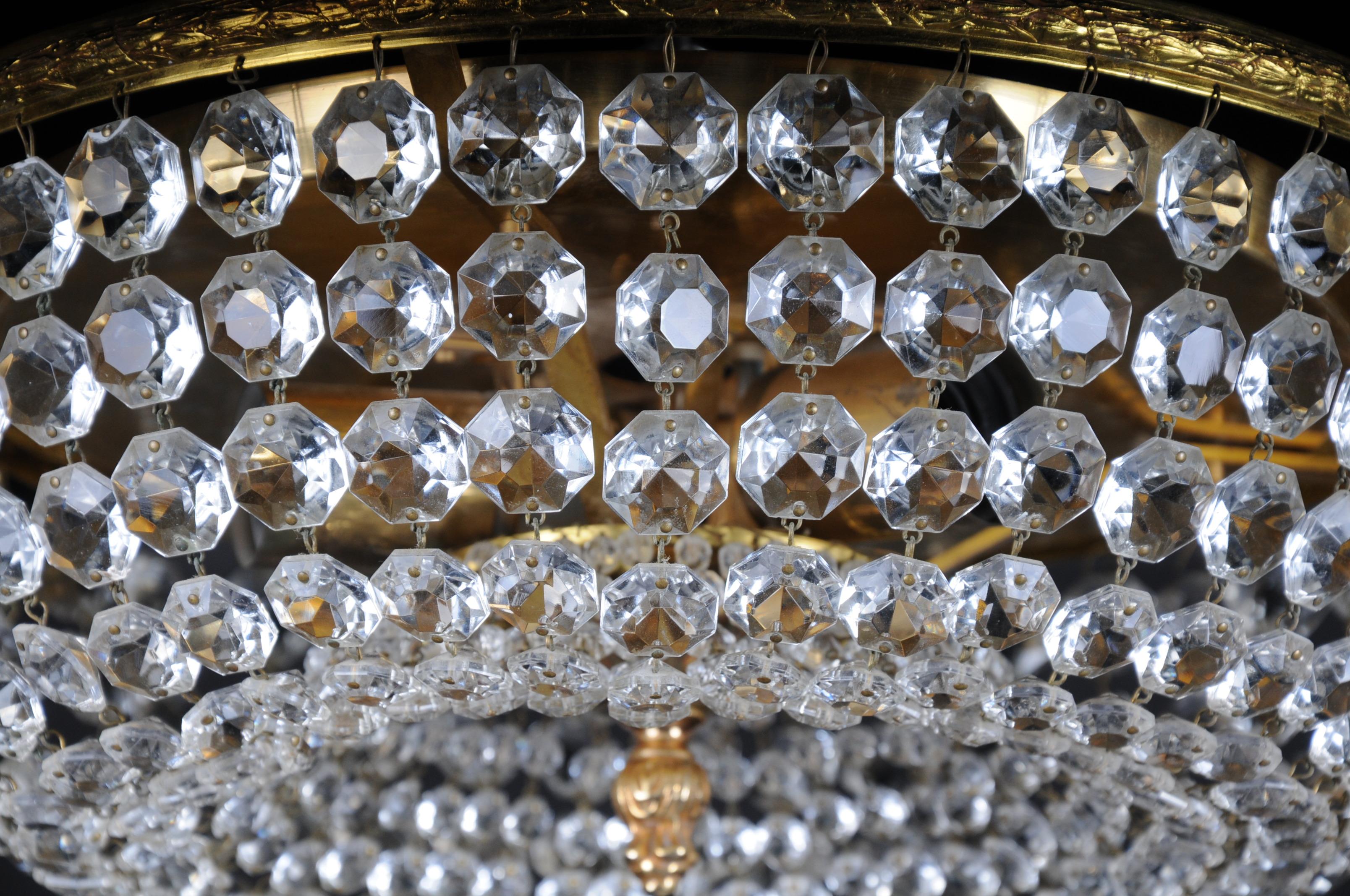 Classic, round ceiling lamp with crystal hangings. Polished brass plate. Extremely high quality workmanship.

(F-101).