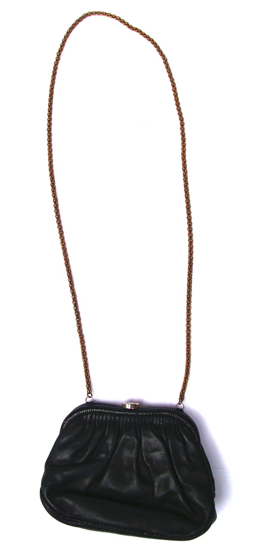 Timeless and classic.  This Chanel lambskin & lizard evening bag has its original long chain strap.  Black lambskin leather with black lizard pull tab, piping & wrapped frame.  The ruching on both sides of the bag  provides the spacious interior. 