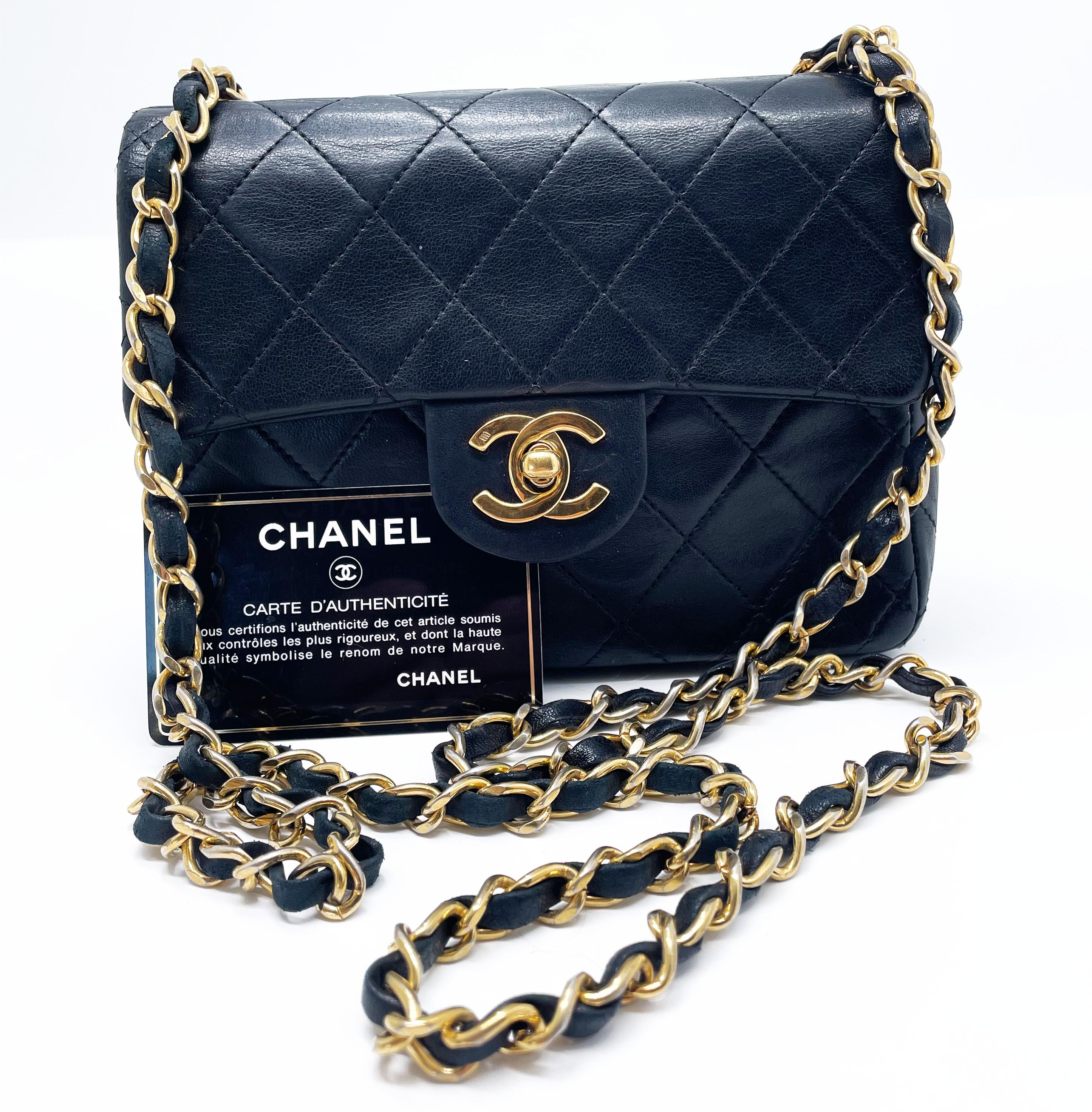 Chanel Mini Timeless handbag in black quilted leather, gold metal hardware, gold metal chain strap interwoven with black leather allowing it to be worn on the shoulder or across the body. Flap closure. A patch pocket on the back of the bag. Interior