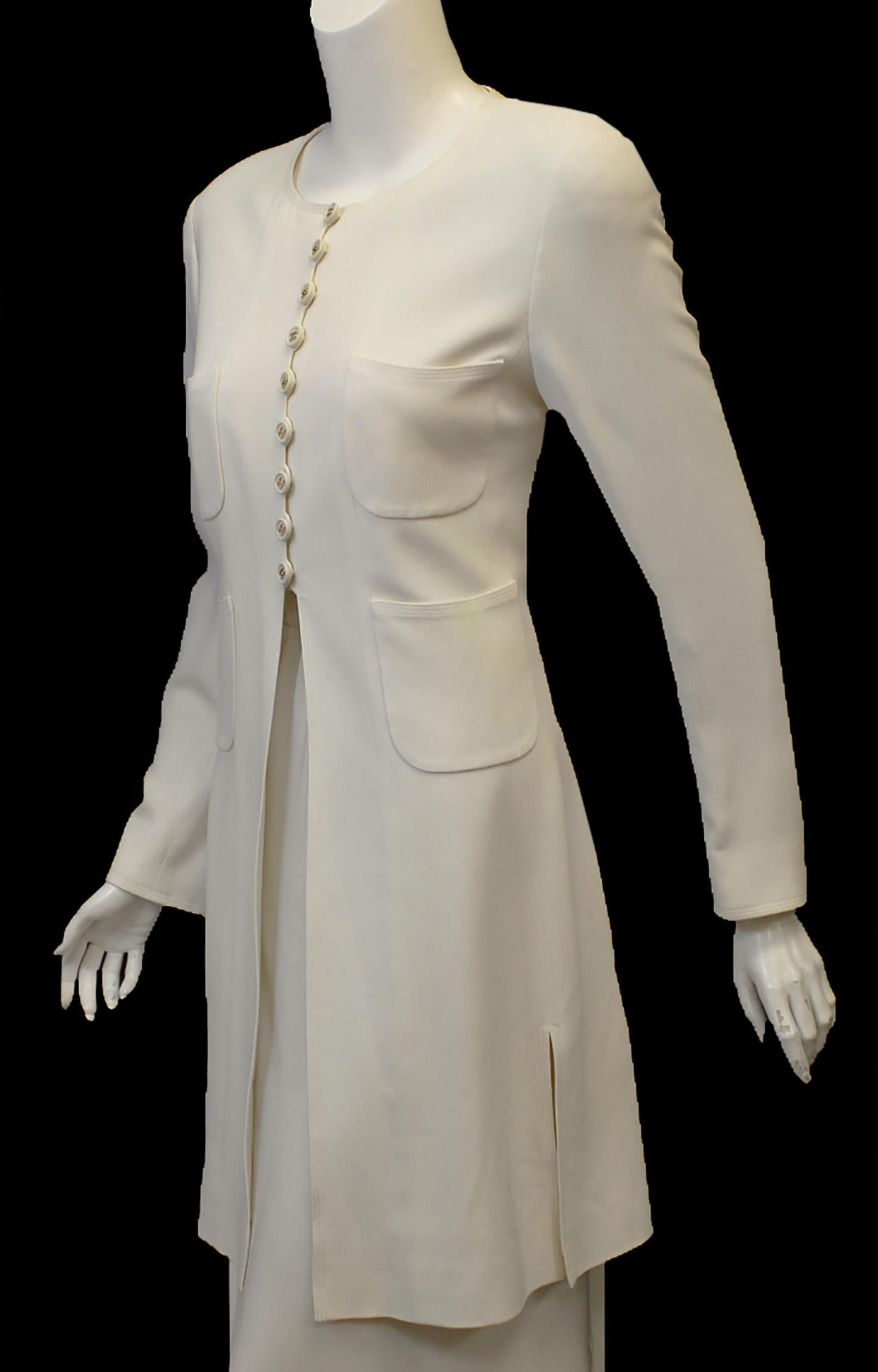 Chanel winter white wool blend long tuxedo style jacket with round neckline includes 9 winter white buttons with gold tone CC's on buttons and loops for closure.  The buttons come down to the waist and is opened to the hem just above the knee.   The