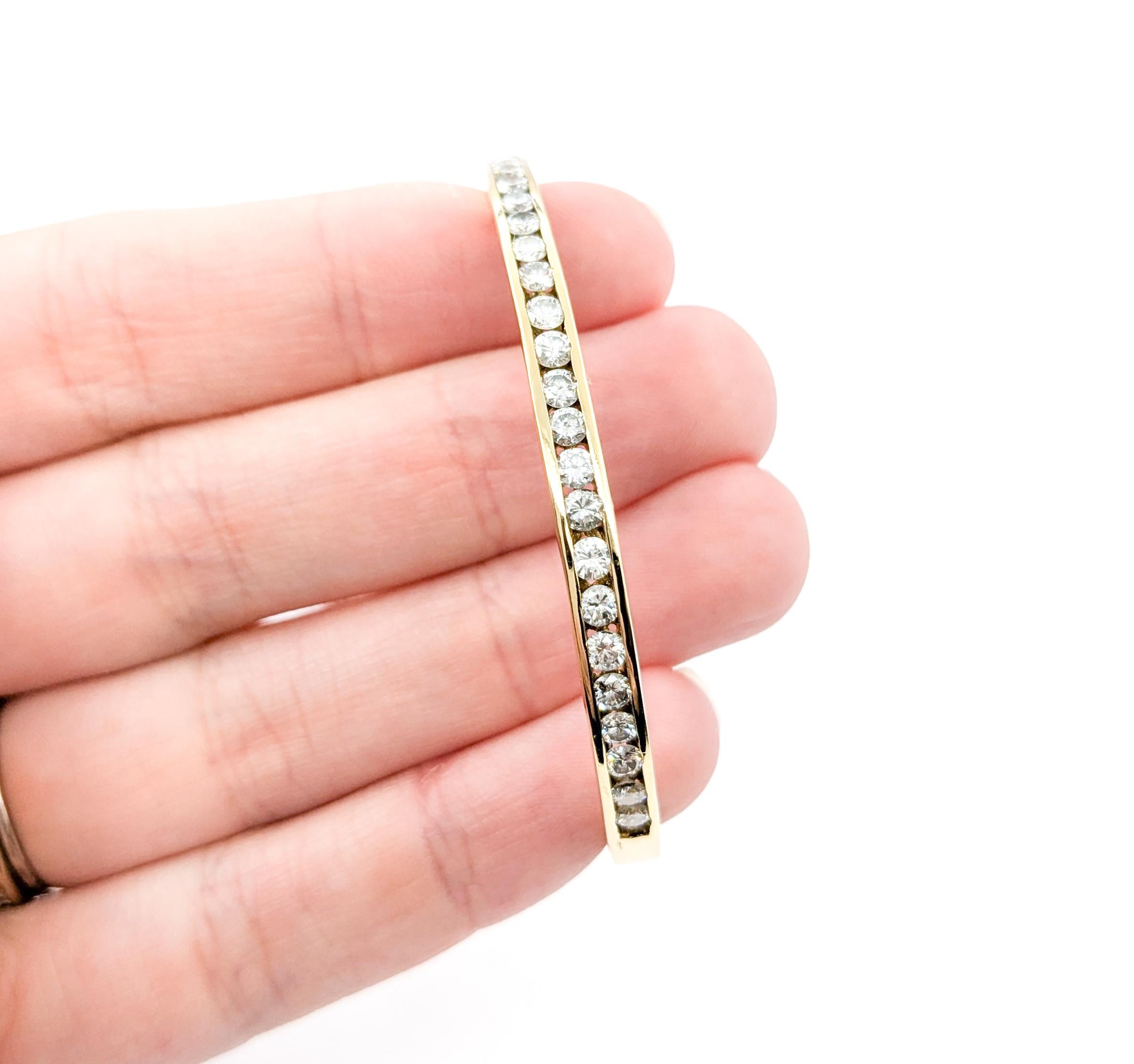 Classic Channel Set Diamond Hinged Bangle in Yellow Gold

Introducing this beautiful diamond bangle bracelet, expertly crafted in 14k yellow gold. The bracelet features 1.50 carat total weight of round brilliant diamonds set in a classic channel