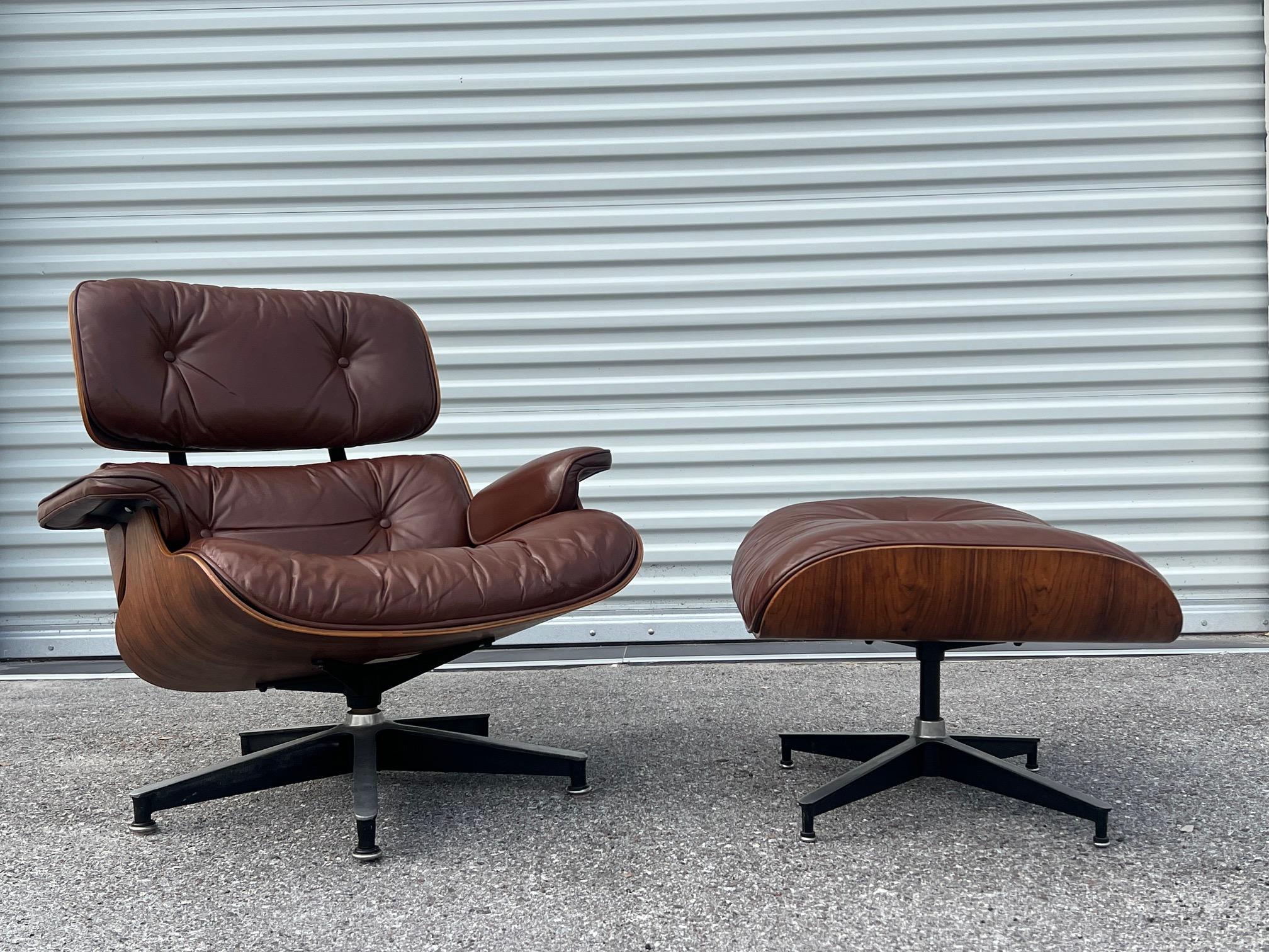Beautiful Charles Eames, Herman Miller lounger chair and ottoman, 1970's. Original cognac brown leather and Brazilian rosewood with unusual grain patterns/flaming effect. The chair has a nicely worn feel with lovely patina. The brown leather has an