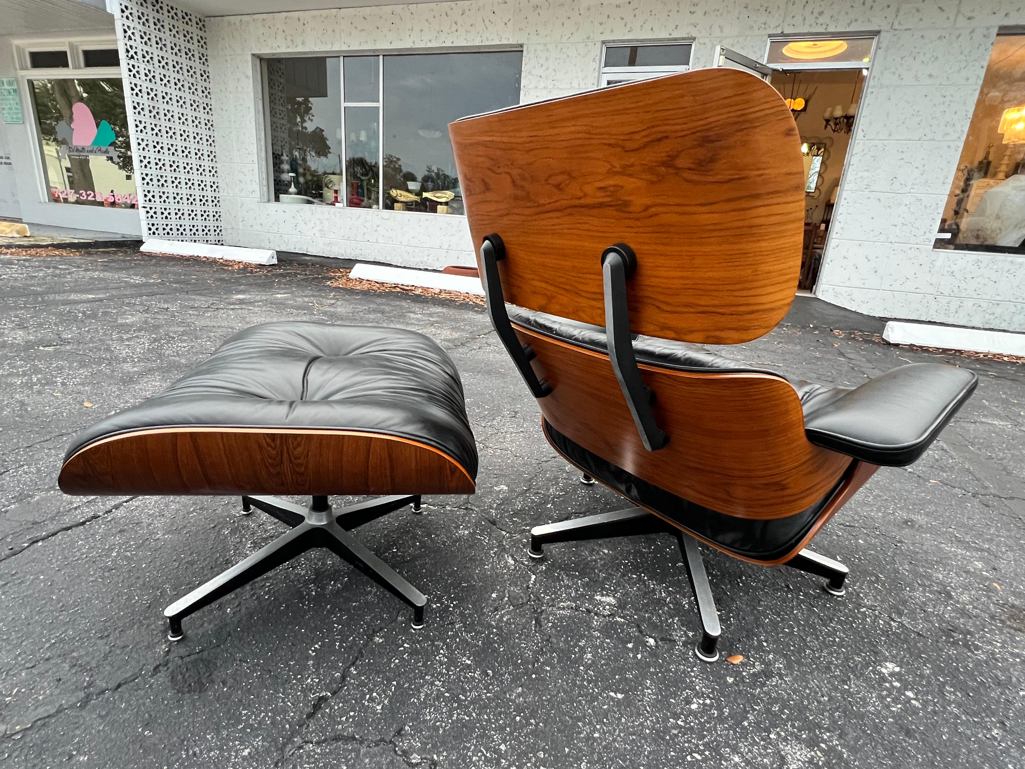 Beautiful Charles Eames, Herman Miller lounger chair and ottoman, 1980's. Original black leather and rosewood with nice graining. The chair has a lightly worn feel with lovely patina. 