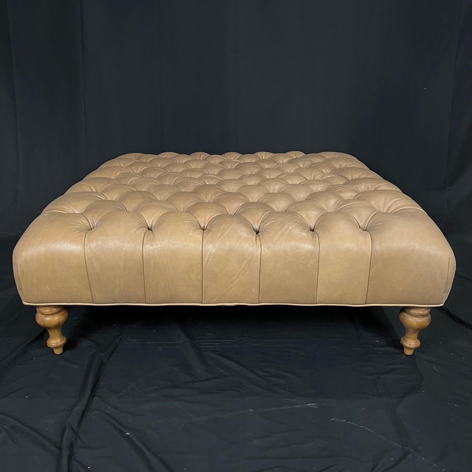 Vintage Chesterfield style leather tufted ottoman in rich, buttery, soft-to-the-touch beige leather, over lovely turned legs on casters. The cushioned top is fixed to the base with a tufted button pattern. Solid hardwood frame.
#4296.