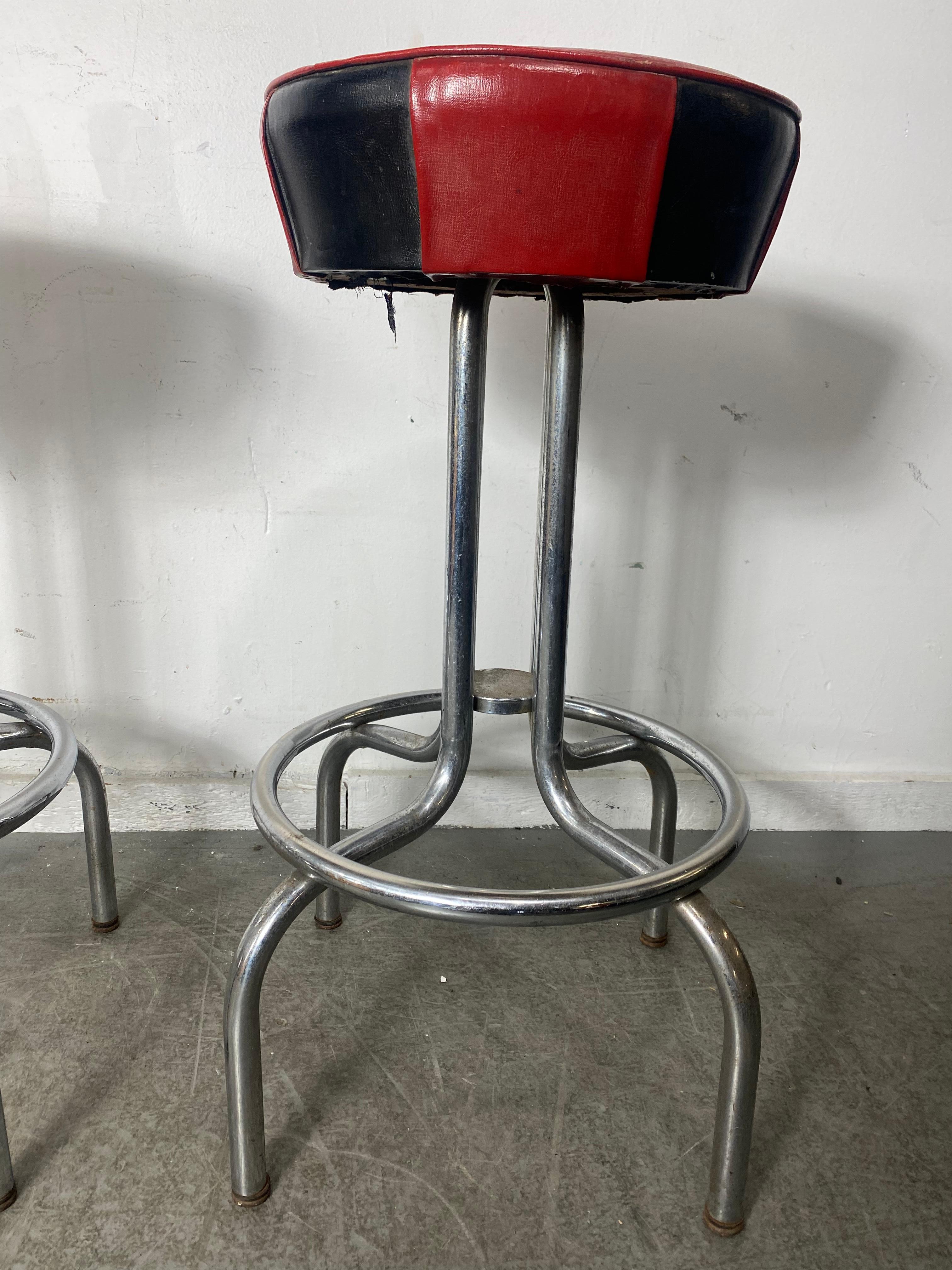 Stunning Pair  Chrome Art Deco Swivel Bar / Counter Stools by Meyer Smith..Super Stylized,, Amazing original Black and Red Naugahyde tops,, Great taper chrome bases with foot rail,, 360% swivel,, 