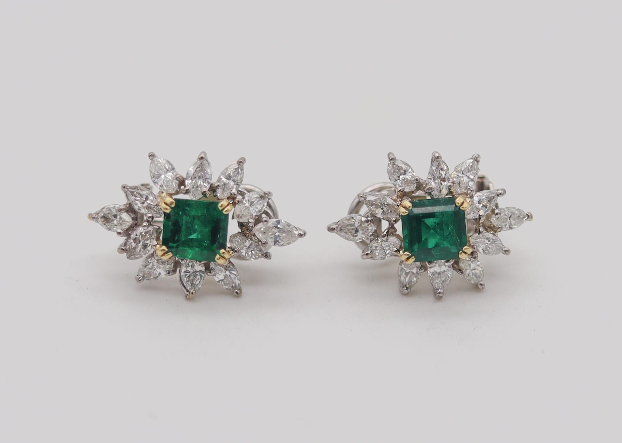 A classic pair of earrings with Emeralds and diamonds.

Very beautiful pair of earrings, crafted with classical patterns in solid white gold of 18 karats and accents of yellow gold in the center for the settings of the emeralds. They are extremely