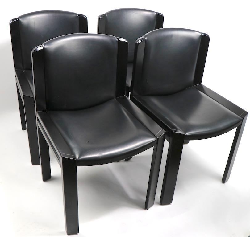 Joe Colombo design for Pozzi Model 300 dining chairs in black lacquer with black vinyl upholstery. Set of four chairs priced and offered as one lot. Very good original condition, showing only light cosmetic wear, normal and consistent with age.