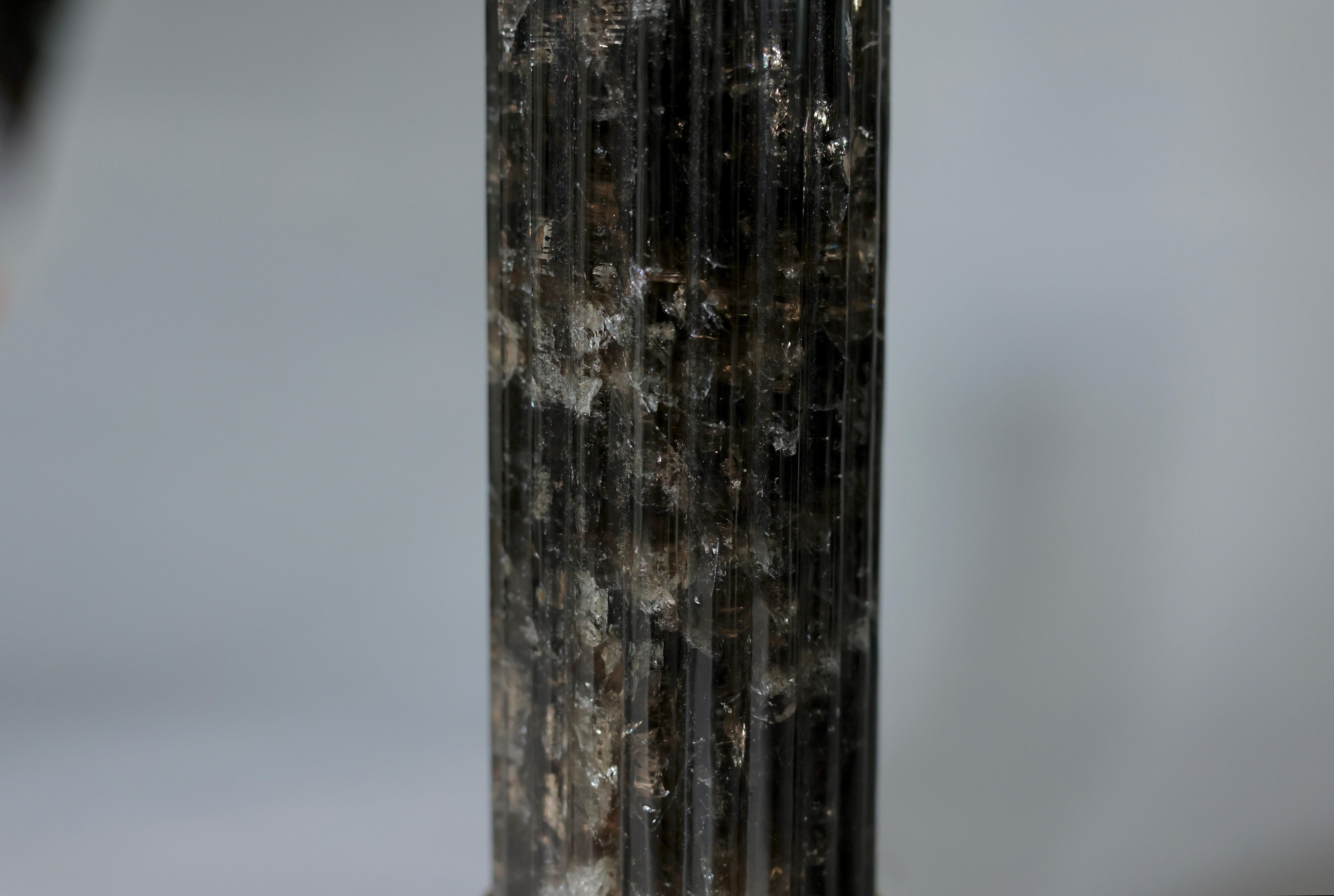 Pair of Finely carved smoky rock crystal ridged columns lamps,polished brass finish.
To the top of the rock crystal 17 inch 
Lampshades are not included 
