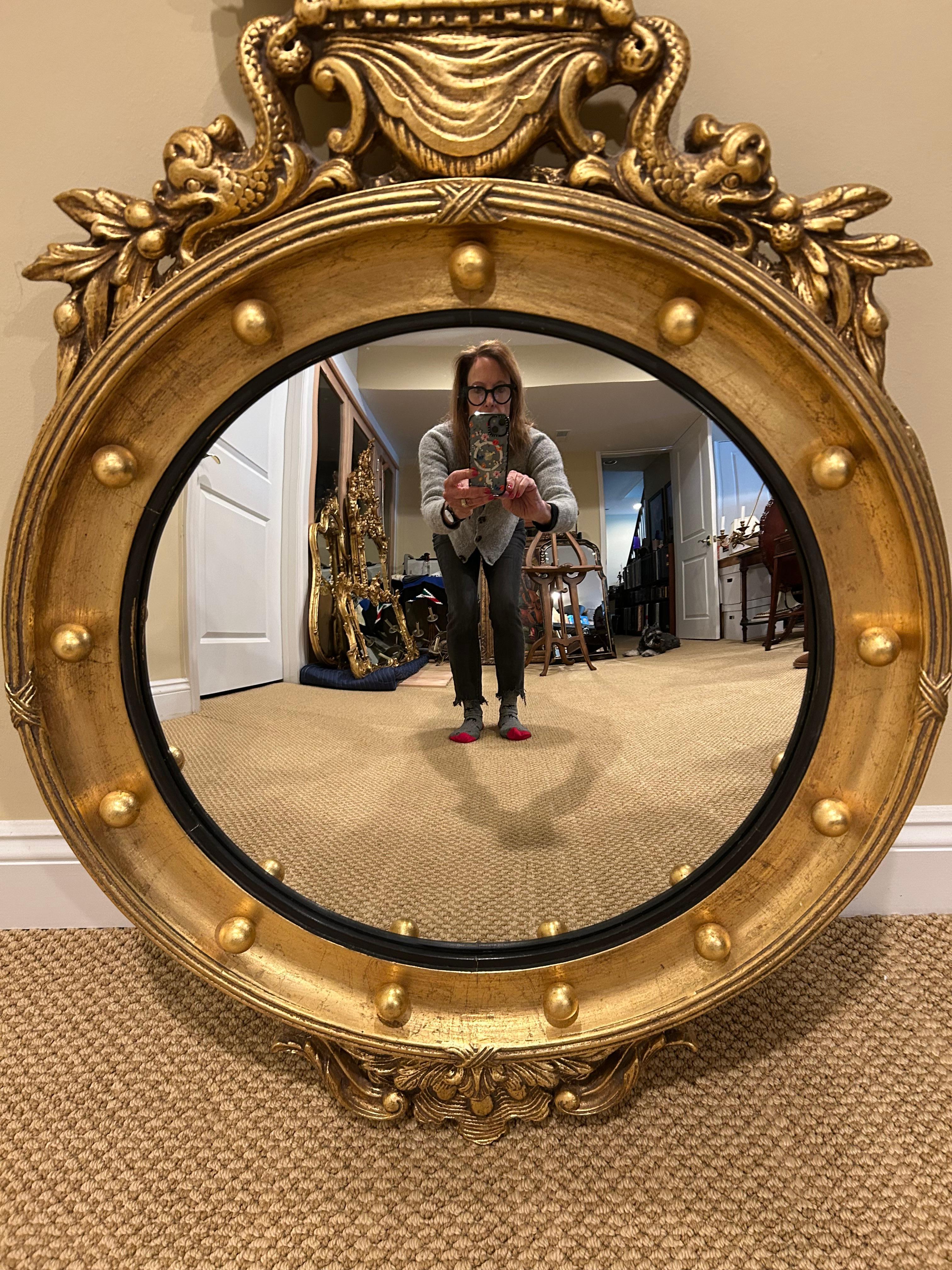 Impressive Convex round mirror with classic Regency style having gesso detailing with large eagle at the top and gold leaf balls around the frame.
Mirror is 18” diameter