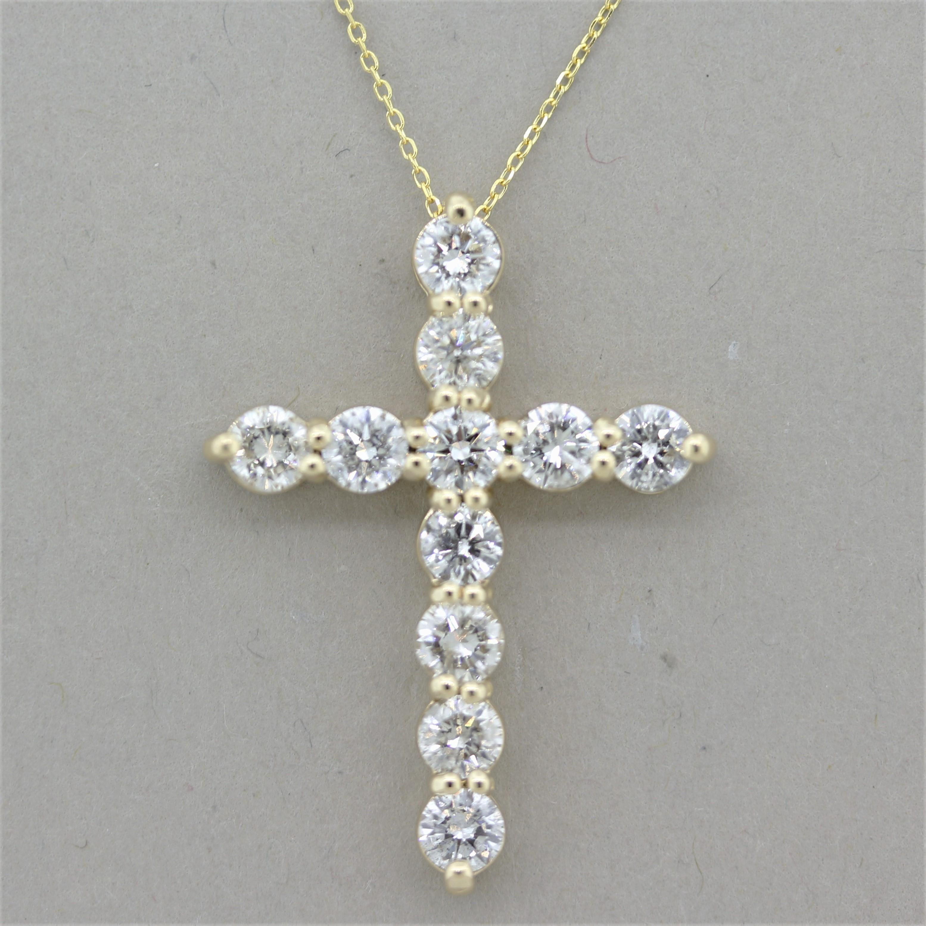 A classic cross pendant featuring 11 large and fine round brilliant-cut diamonds weighing a total of 2.37 carats. Set in 14k yellow gold and comes with a fine yellow gold chain with an extra bail allowing it to be worn at 16 or 18 inches.

Cross
