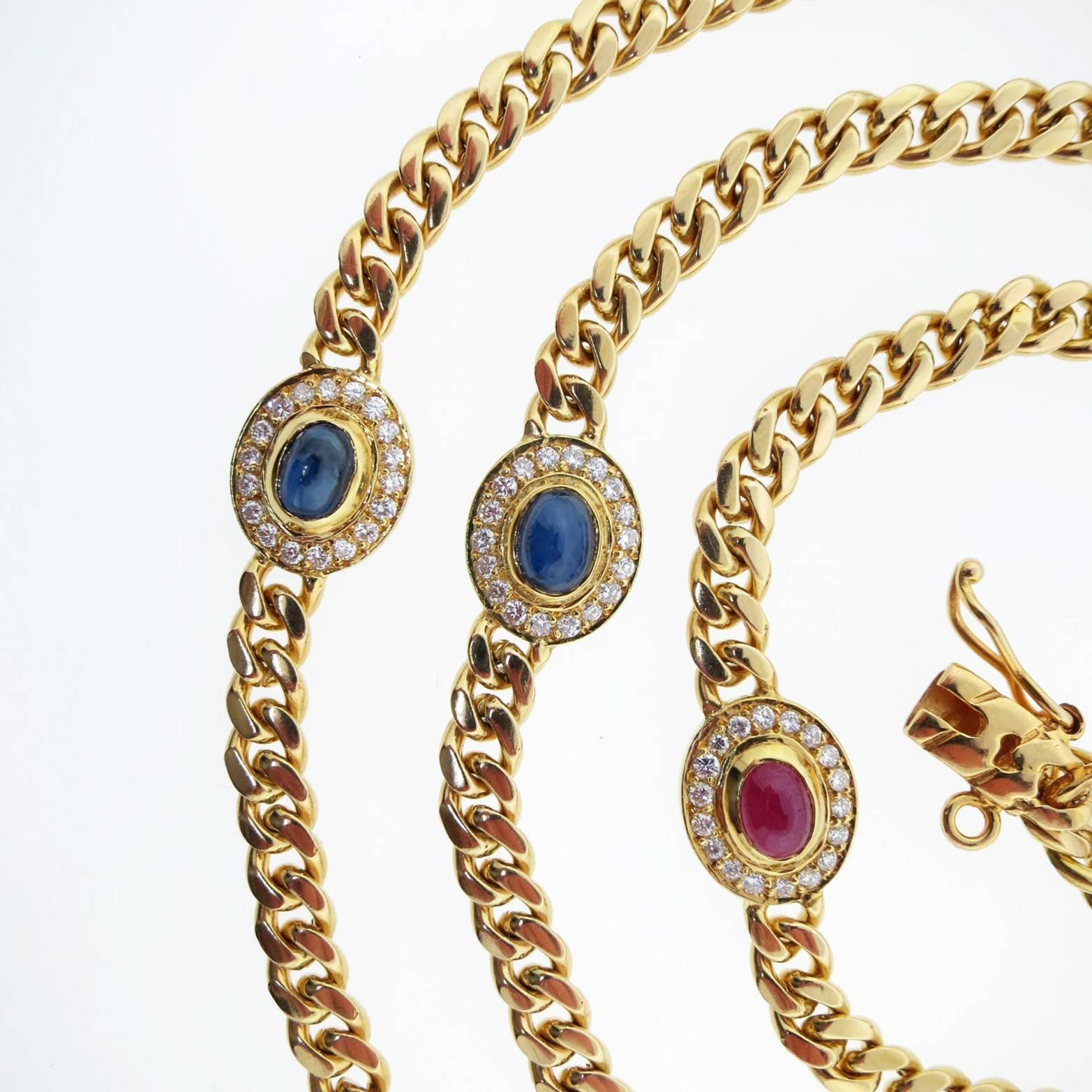 18kt. yellow gold curb link necklace measuring 35 inches in length weighing 107.4 gr. The necklace is set with two alternating cabochon sapphire, emeralds and rubies and is surrounded with 18 bead set round brilliant cut diamonds totaling approx.