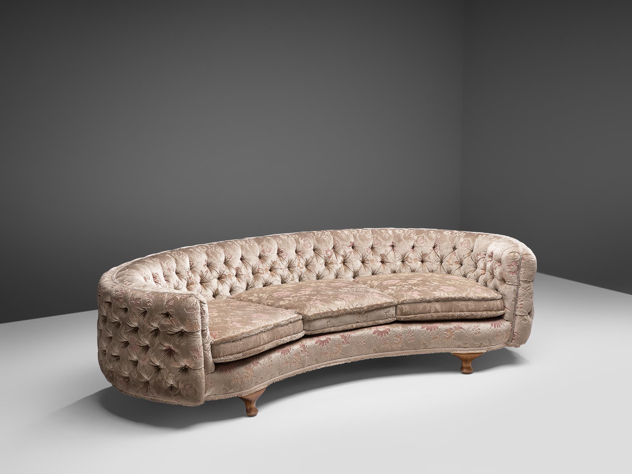 Banana sofa, beige floral fabric and oak, France, 1950s

This voluptuous sofa is executed with elegant wooden legs and a light colored, velvet fabric with a floral embroided pattern. The sofa is tufted in a theatrical way, in both the backrest as