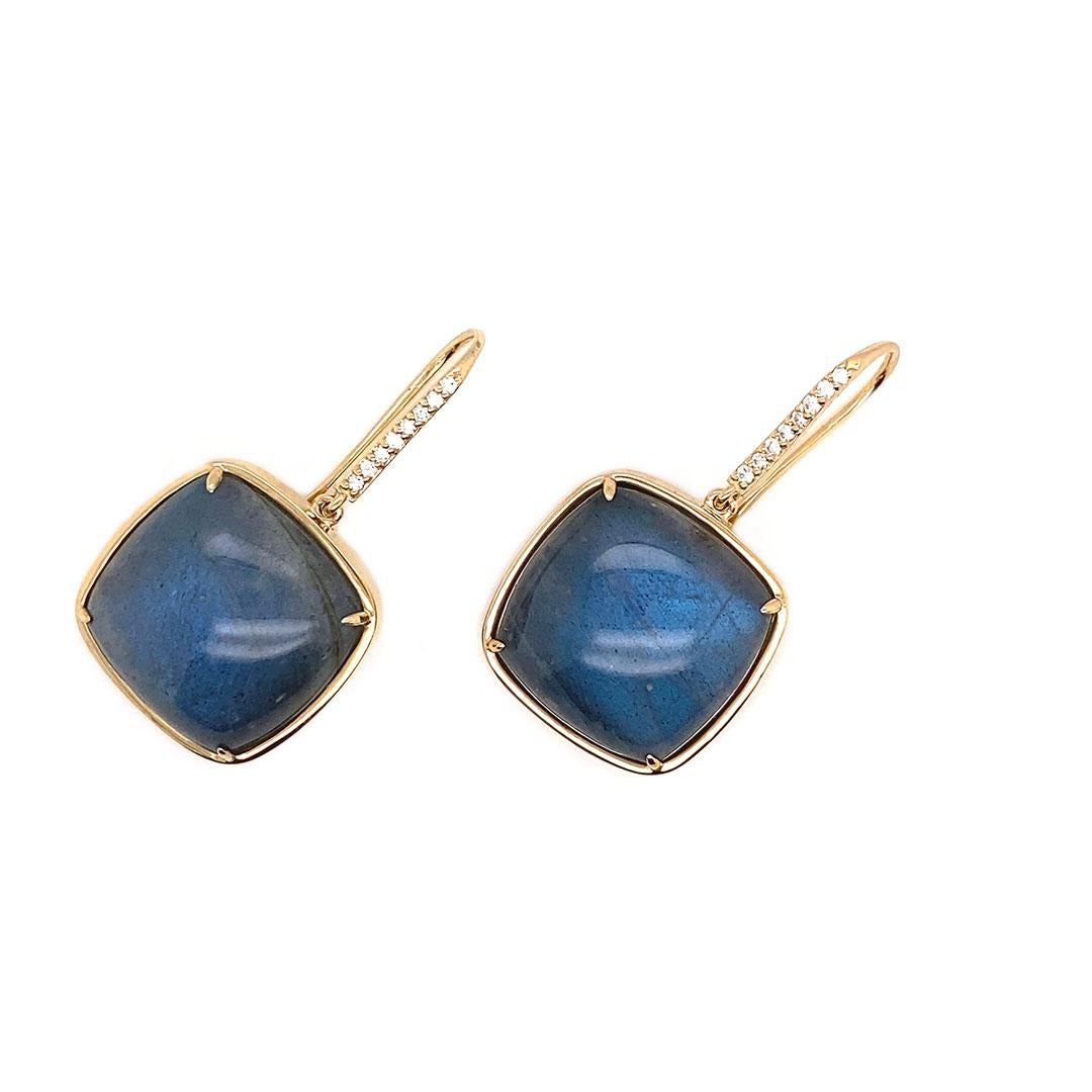 These labradorite cabochon cushions cut earrings with diamond ear hooks show a rich blue hue.  The gold frames are the perfect way to outline these head turning stones.  The diamond ear wires add the sparkle you need.  Length 1.25 and a width of .50