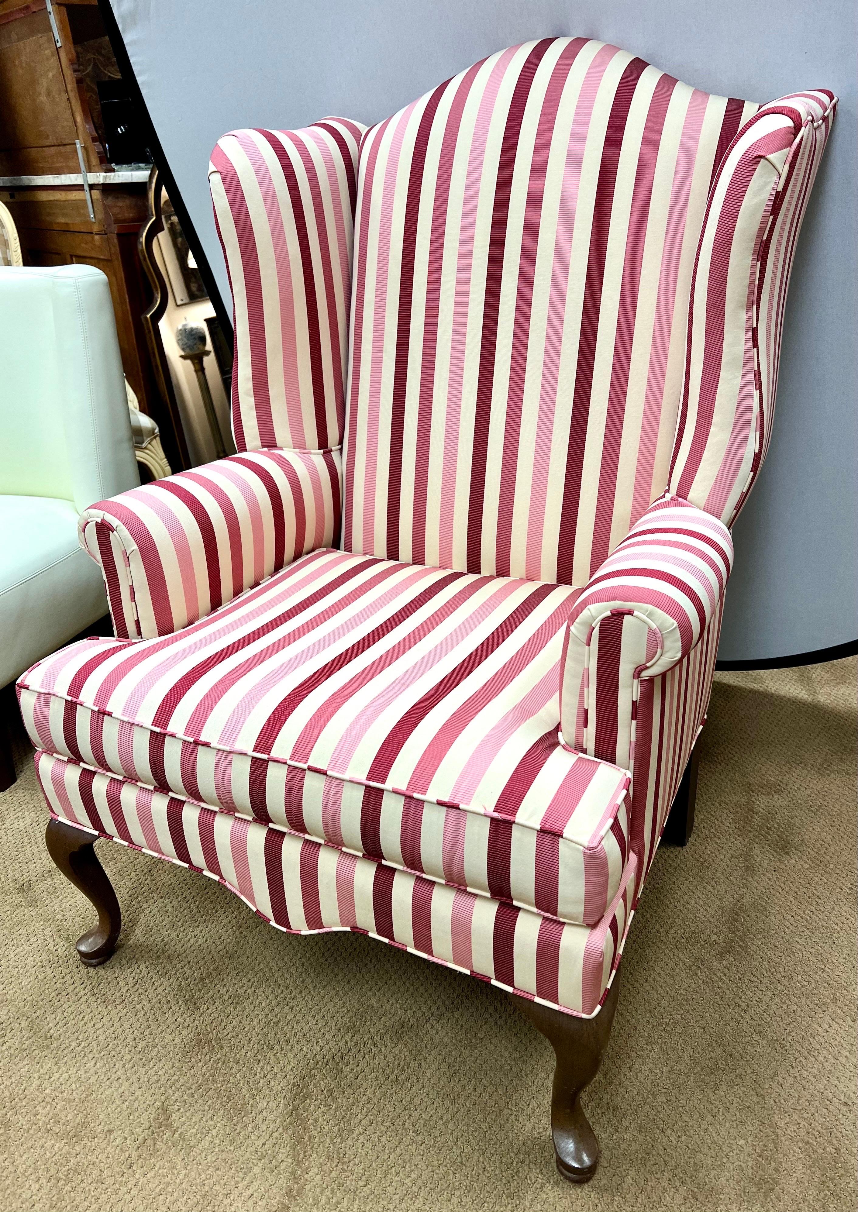 Elevate your interior with this exquisite custom upholstered wingback chair, cloaked in a charming striped fabric.  This one-of-a-kind piece seamlessly blends timeless design with contemporary allure, making it a perfect addition to your home.