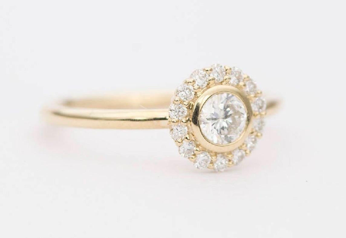 ♥  Solid 14K gold ring set with a round brilliant diamond in the center, then surrounded with a halo of white diamonds
♥  The head of the ring measures 7.5mm across (center stone and the halos).

♥  US Size 5 (We can resize up or down 1 size for