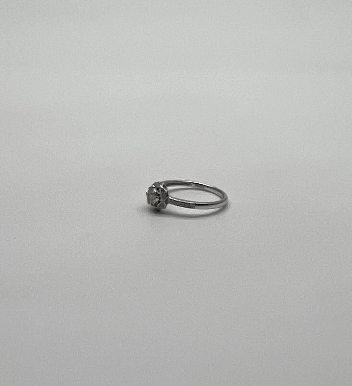 This refined piece features a delicate band adorned with a central cluster of sparkling diamonds, creating a captivating focal point.
The intricate setting enhances the brilliance of the stones, offering a timeless and sophisticated design.
A