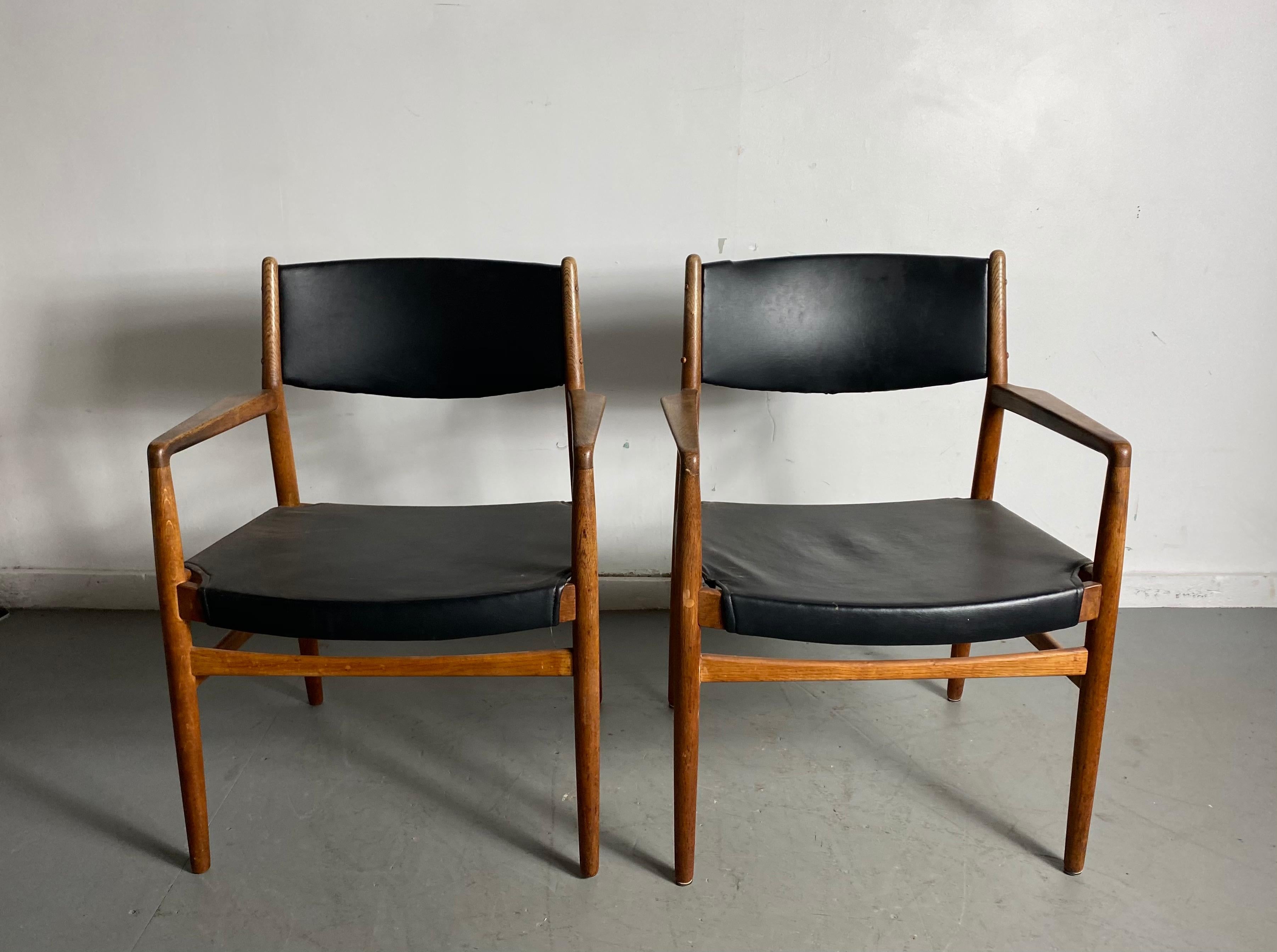 Classic Danish armchairs in solid oak by Knud Andersen, J.C.A. Jensen, Aarhus Denmark, nice original condition, retains original finish, patina, extremely comfortable, solid, sturdy construction.