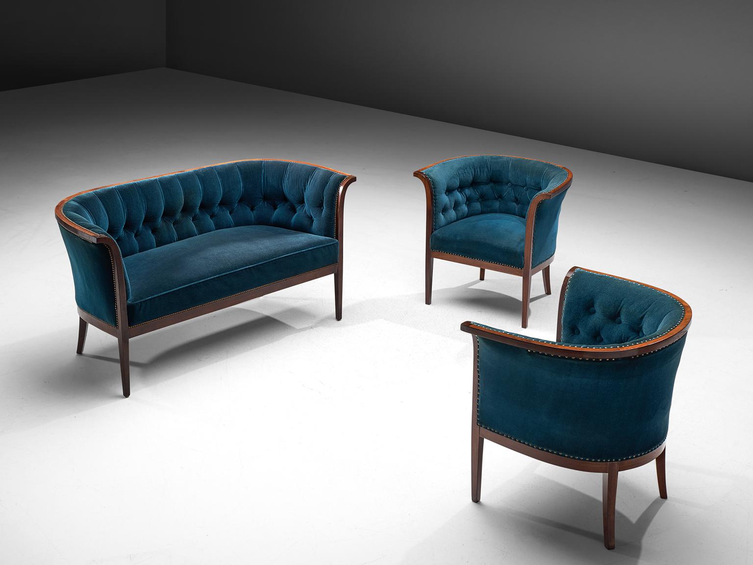 Three-seat sofa and two armchairs, blue velvet upholstery, wood, Denmark, 1940s.

This velvet blue Danish sofa and matching armchairs feature a backrest that is tufted and the seat is executed in one piece. The seat is thick and comfortable. The