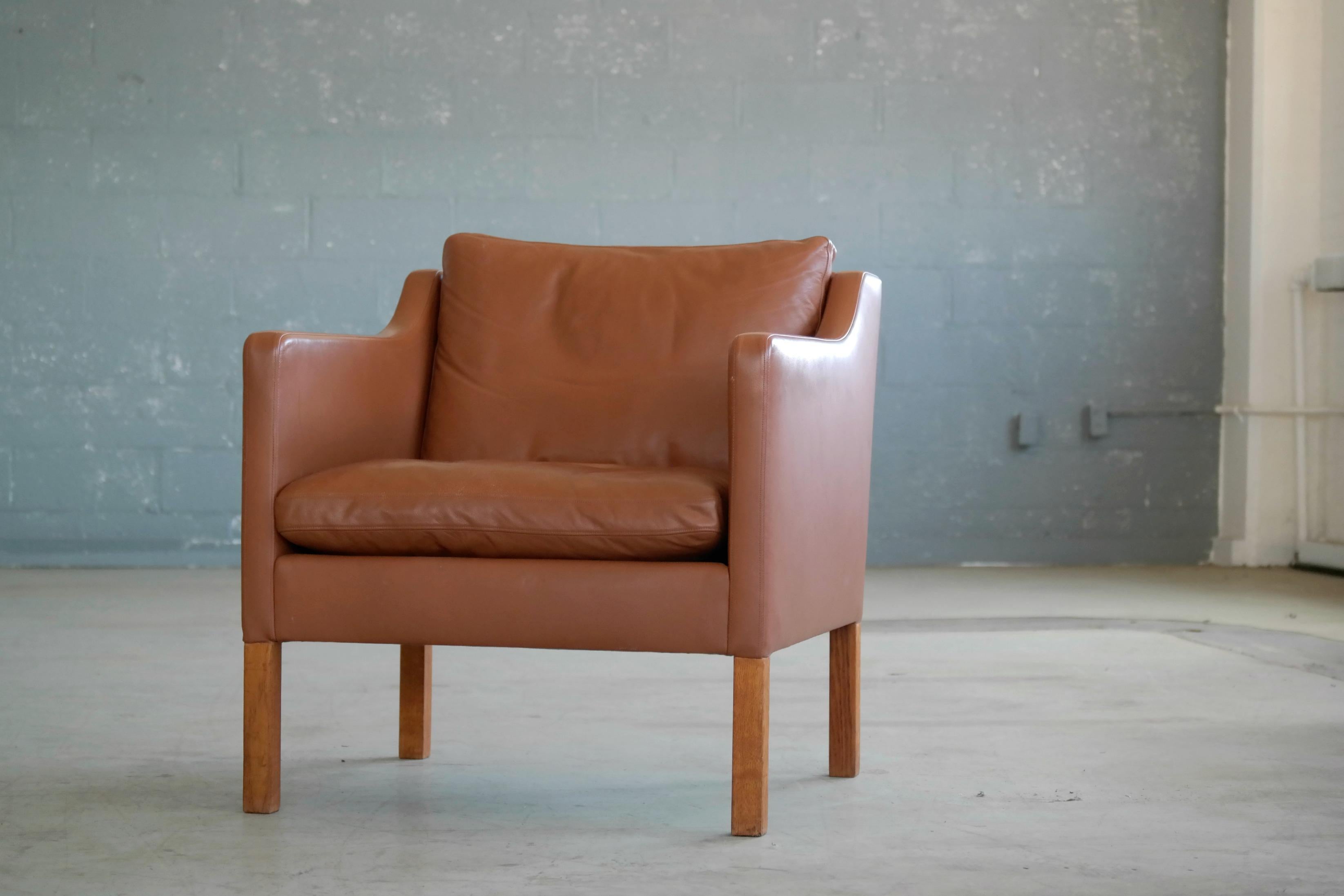 Mogen Hansen produced version of Børge Mogensen's designed lounge chair model 2421 one of the most elegant Classic midcentury Danish lounge chairs ever made and a design that will just never go out of style. Supple cognac colored leather with