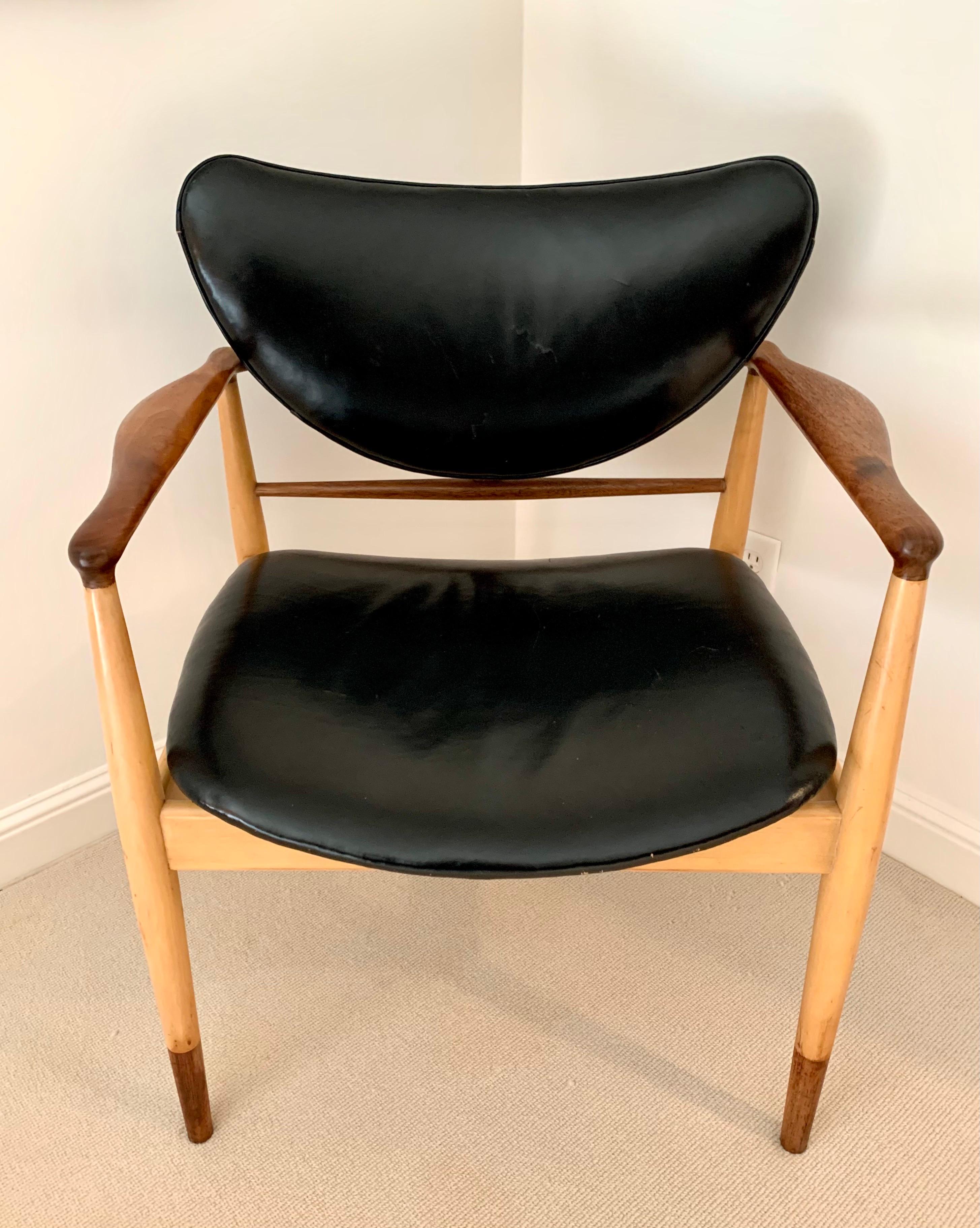 Ultra rare Finn Juhl #48 chair features a maple and walnut two-tone frame with black leather upholstery. It is both elegant and comfortable. Perfect in a dining room or conference room See our other listing for matching chair.
