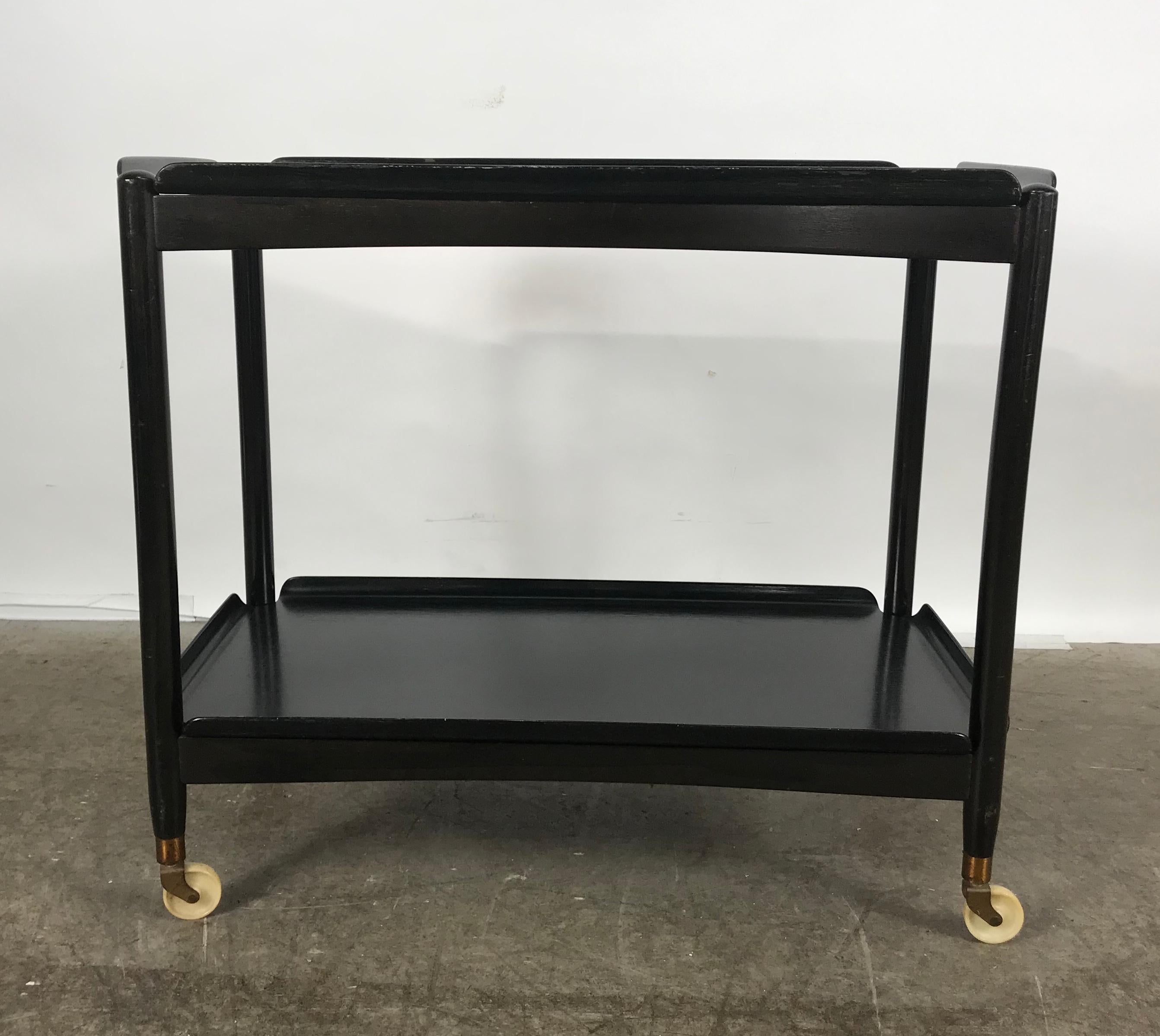 Classic Danish modernist two-tier collapsible rolling tray table / serving cart, retains original black lacquer finish, bentwood removable trays, stamped made in Denmark. Stunning.