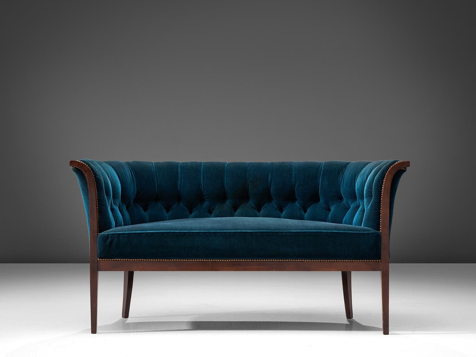 Three-seat sofa, blue velvet upholstery, wood, Denmark, 1940s

This velvet blue Danish sofa features a backrest that is tufted and the seat is executed in one piece. The seat is thick and comfortable. The defining features of this piece are the