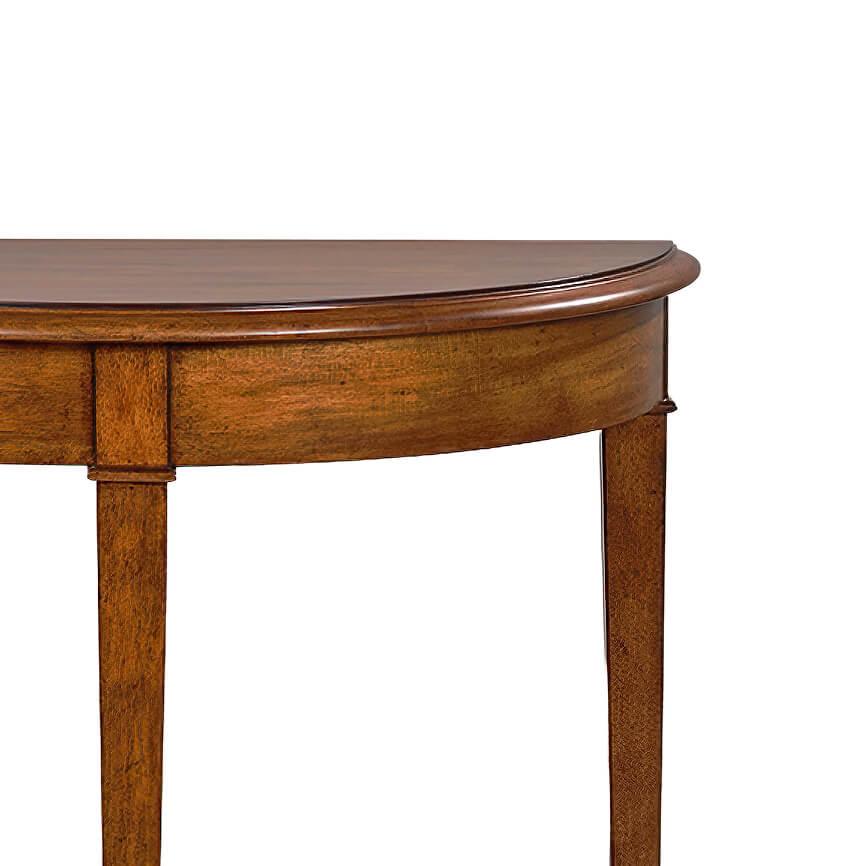 A Classic walnut stained demilune console table with a molded edge, three square tapered legs, and a shaped shelf stretcher base.

Dimensions: 34