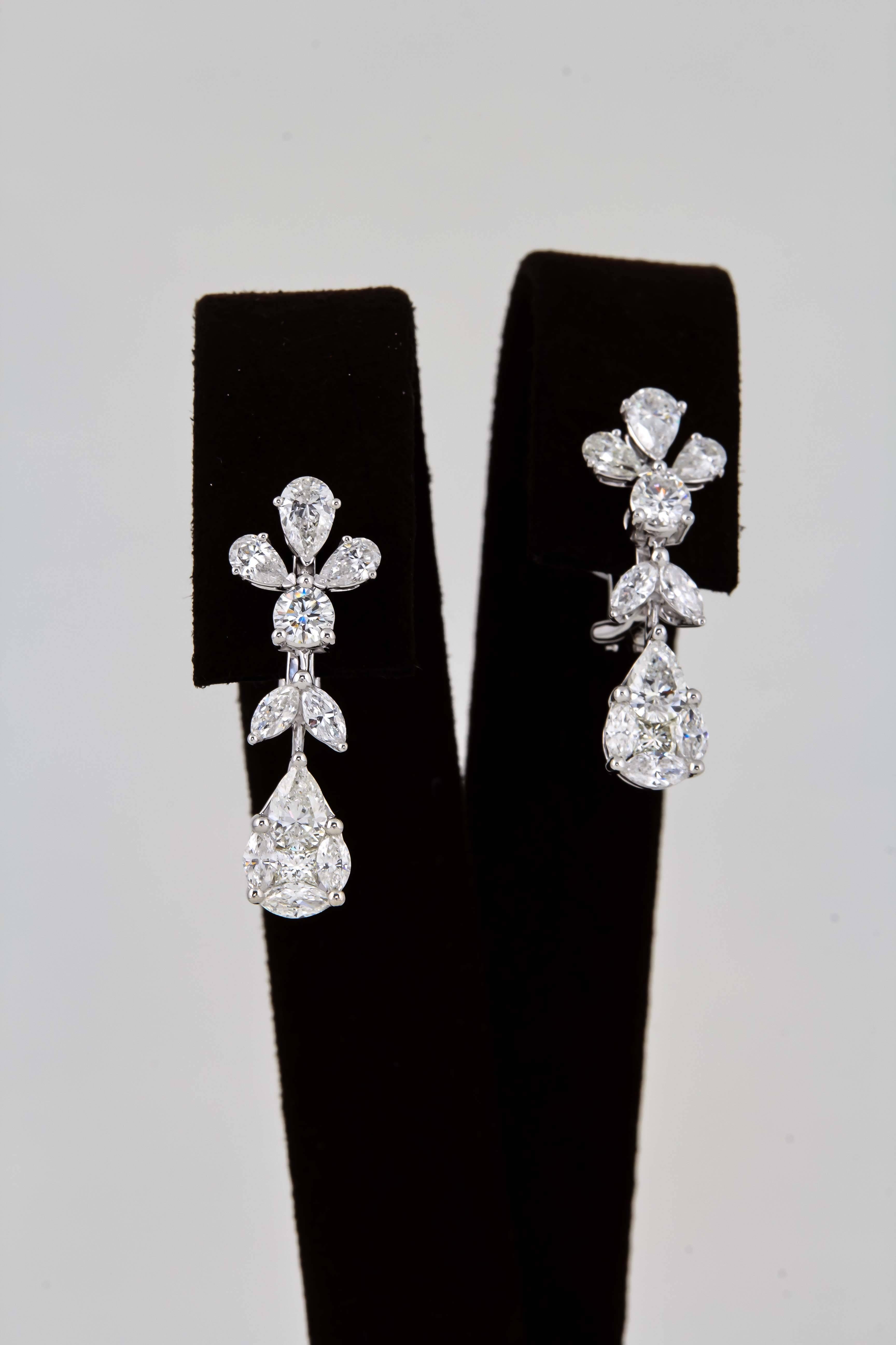 
A stunning pear of earrings in a timeless design.

3.41 carats of pear, marquise, round and special cut diamonds. 

F/G in color VS clarity set in 18k white gold. 

The pear shape drop is an illusion made up of a number of special cut diamonds. The