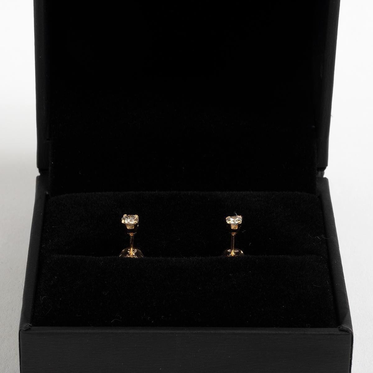 Our classic diamond ear studs in 9k yellow gold feature diamond solitaires of est. .20ct