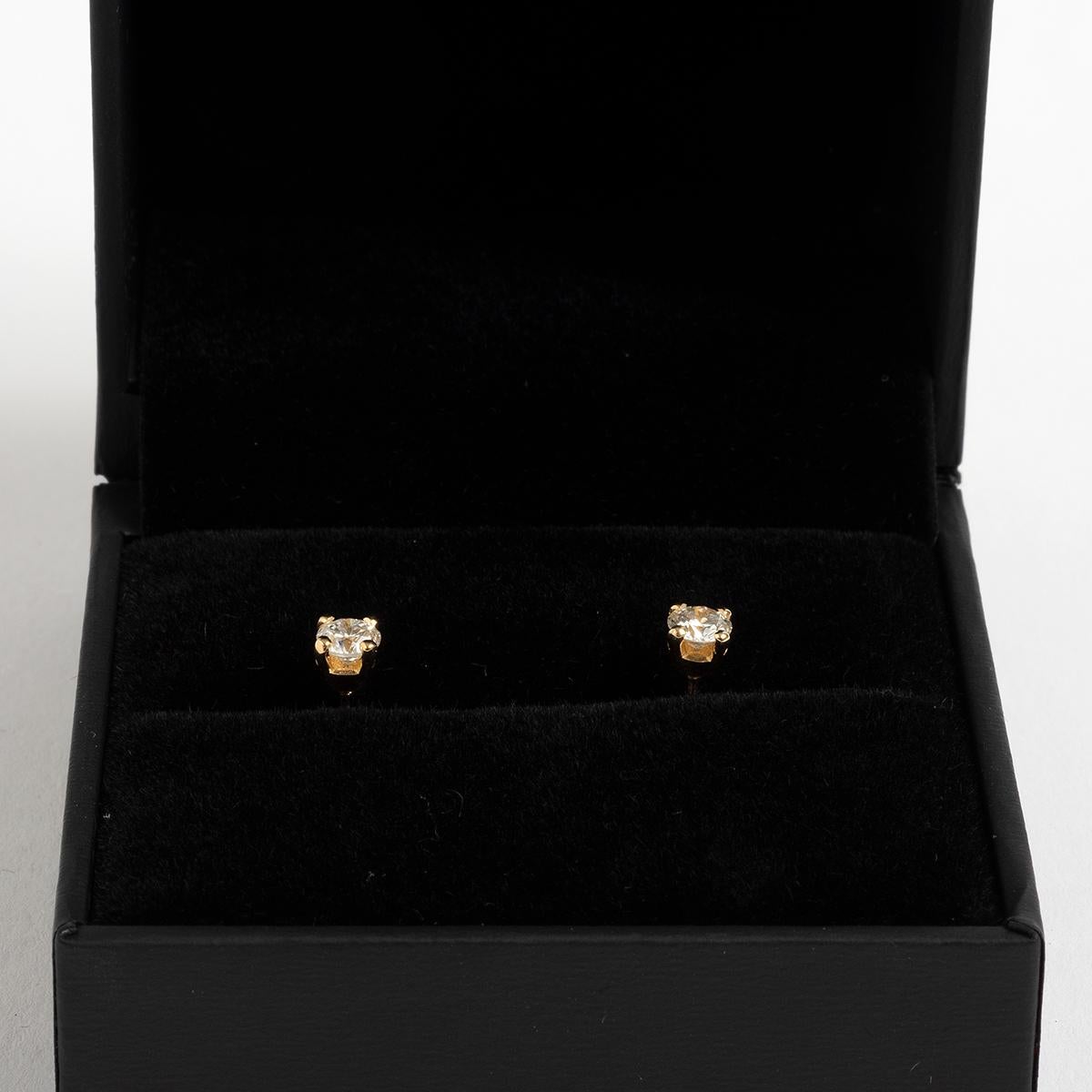 Our classic diamond ear studs in 9k yellow gold feature diamond solitaires of est. .50ct