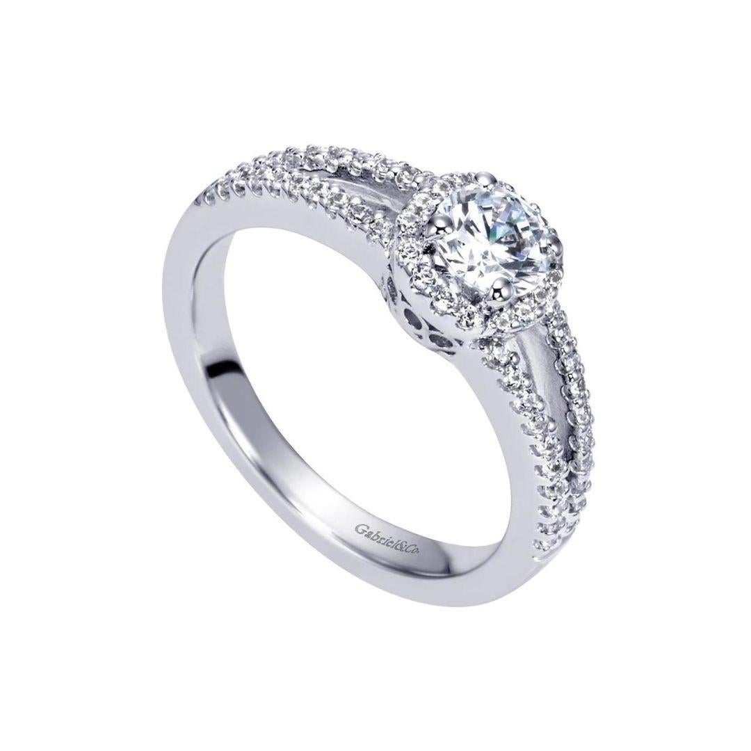 Classic Diamond Halo Engagement Ring with Euro Style Split Shank in 14k White Gold.﻿ Center natural white brilliant cut diamond weighs 0.50 ct, H color, SI2 clarity. Side diamonds are full cut, total carat weight 0.25ctw, H color, SI1 clarity.