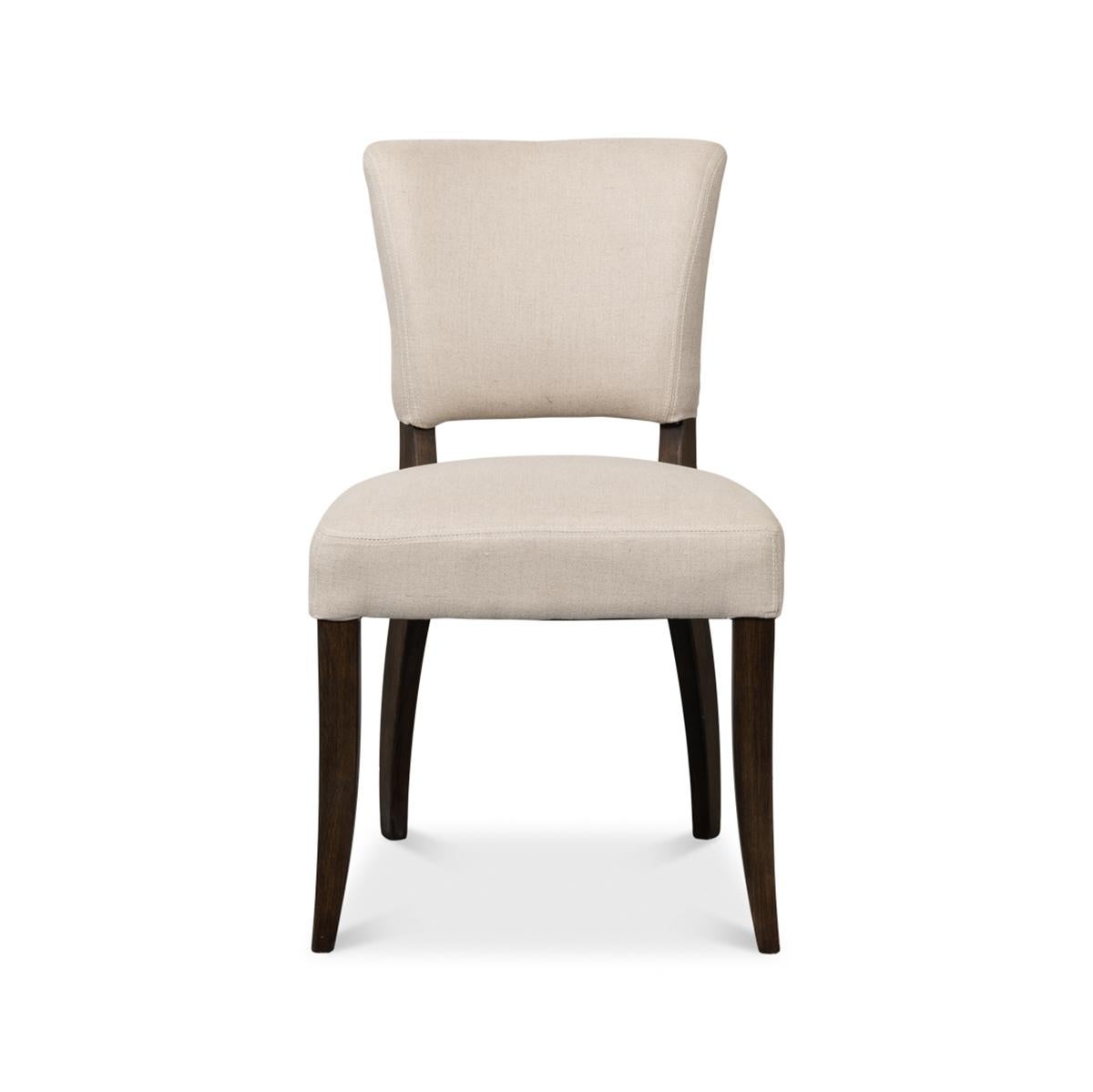 Classic dining side chair, with graceful lines, a full curved back to accentuate comfort, and a linen fabric that speaks to soft tactile luxury. With brass nailhead details on tapered legs.

Dimensions: 20