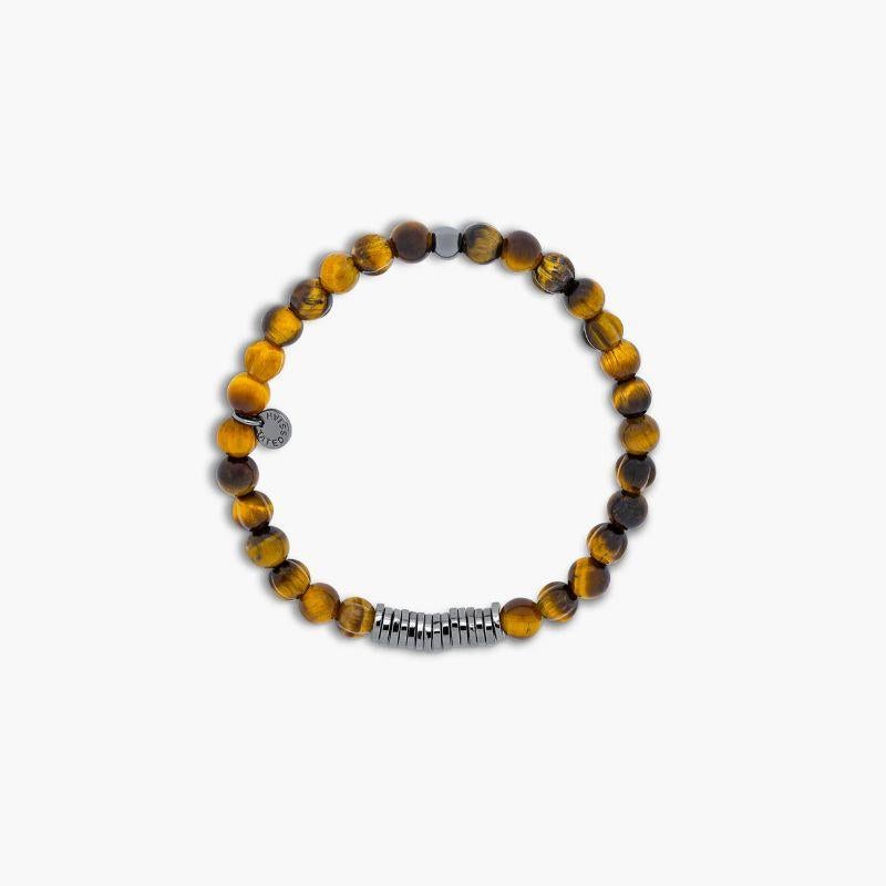 Classic Discs Bracelet with Tiger Eye and Rhodium Plated Silver, Size L

Tiger eye beads are paired with hand-polished, black rhodium plated sterling silver discs. Crafted and carved uniquely by hand in our Imperial Wharf, central London workshop,