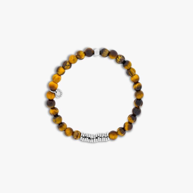 Classic Discs bracelet with tiger eye and sterling silver, Size L

Tiger eye beads are paired with hand-polished, rhodium-plated sterling silver discs, crafted in our Imperial Wharf, central London workshop. Designed onto a closed elastic which