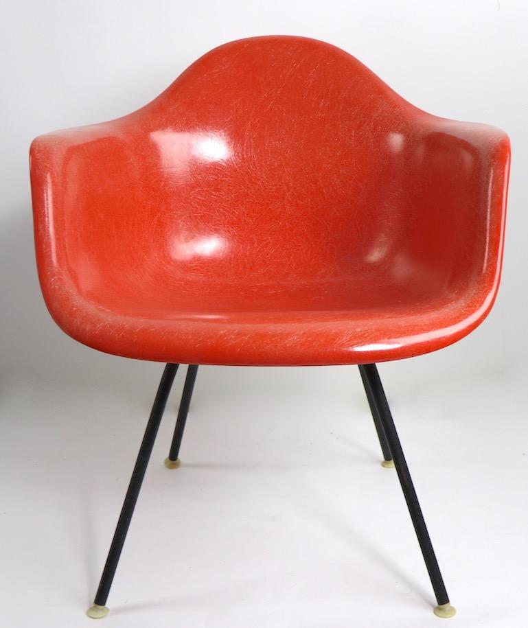 Orange fiberglass bucket chair, designed by Charles and ray Eames foir Herman Miller ( Zeeland Mich. ) This example is in very fine, original condition, clean and ready to use. Measures: Seat H 16 x Arm H 23 x Total H 28 inches.