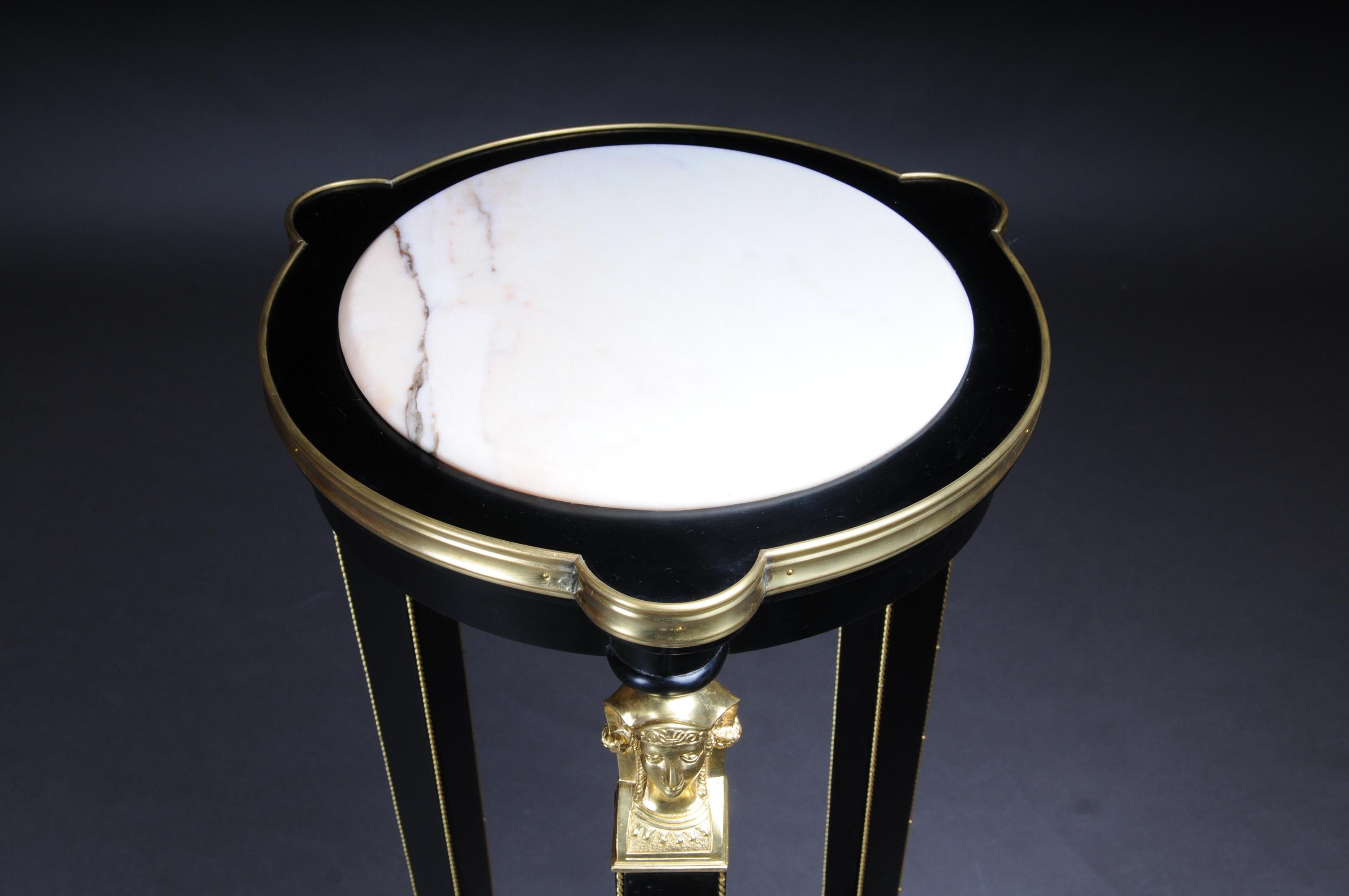 Classic Ebonized Karyadite Pillar / Pedestal in Empire Style, black gold

Piano black polished veneer on solid wood. Round body with marble slab on Karyadites with tapering square legs in sabots ending on three sided recessed base plate. The