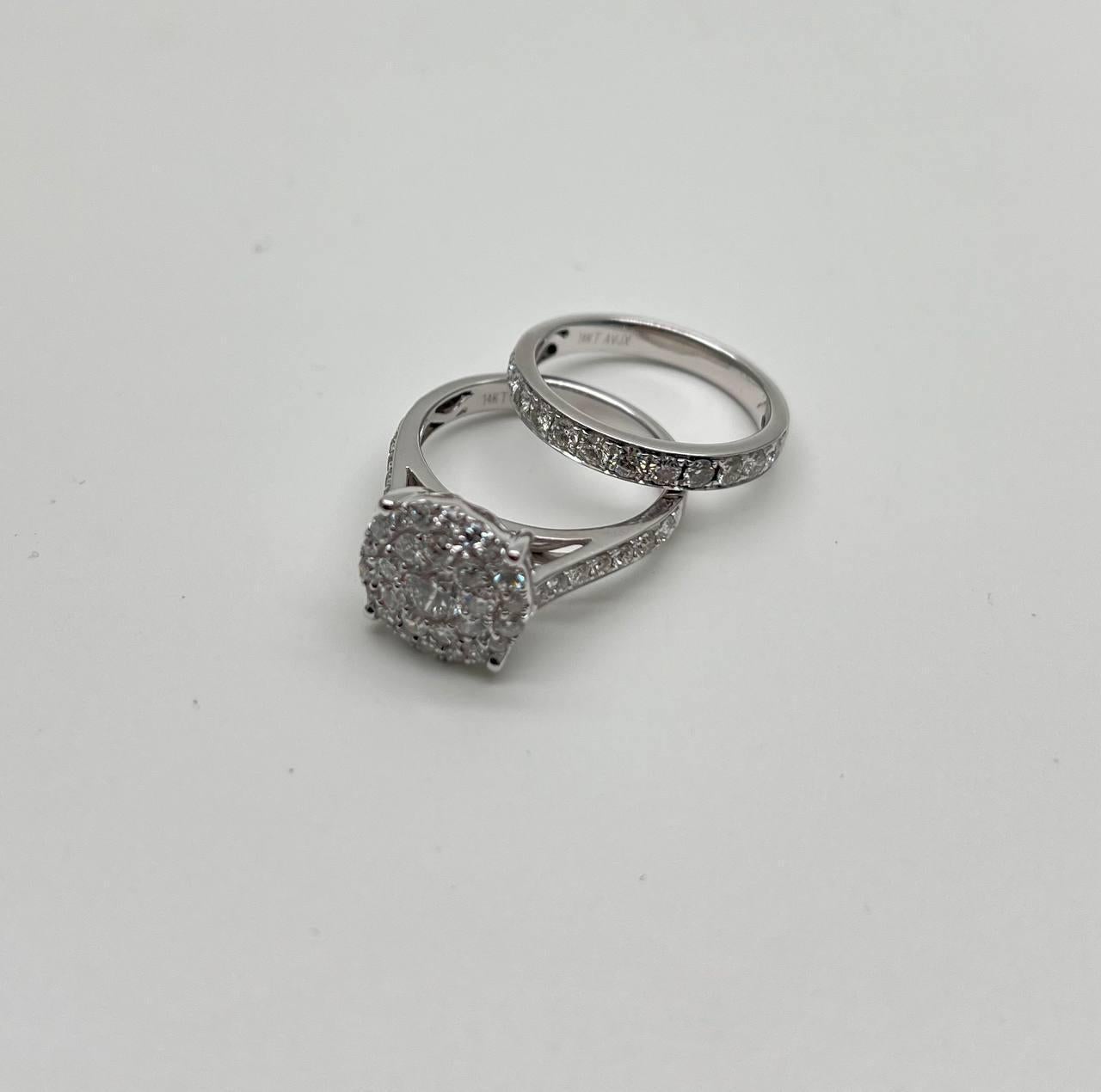 This exquisite ring is crafted with precision, featuring a stunning cluster of round brilliant diamonds set in a polished white gold band. The design showcases a double band encrusted with smaller diamonds, enhancing the central cluster's