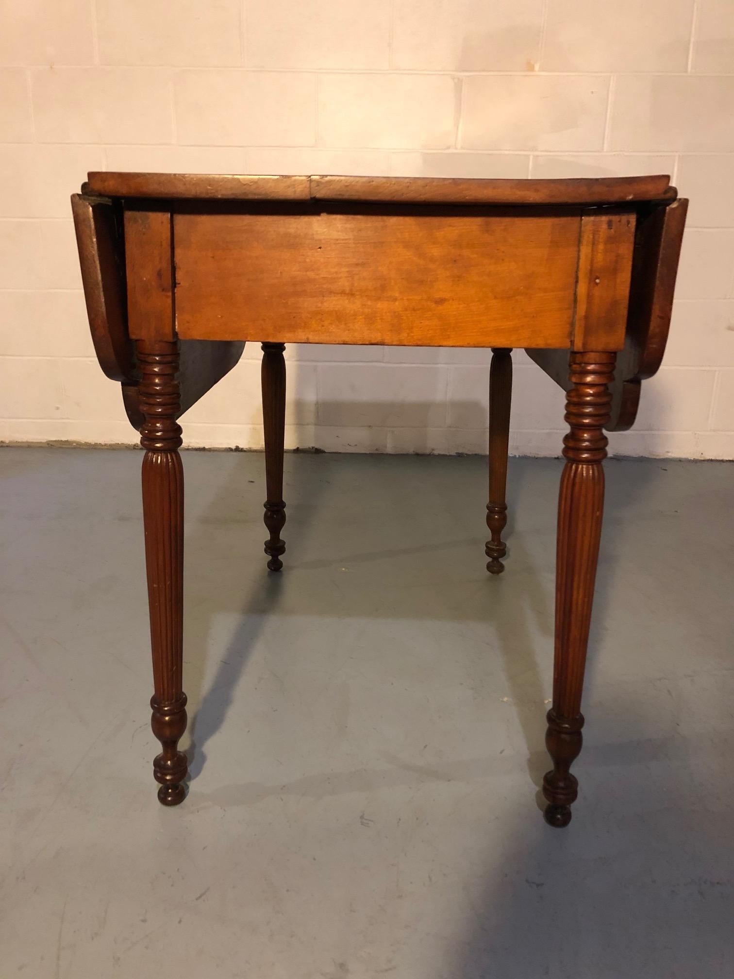 A handsome versatile cherry English drop-leaf table with lovely turned legs that's a great size for use as a small dining table or occasional table. 40” wide with the leaf’s extended. (Each leaf is 10” wide).
 