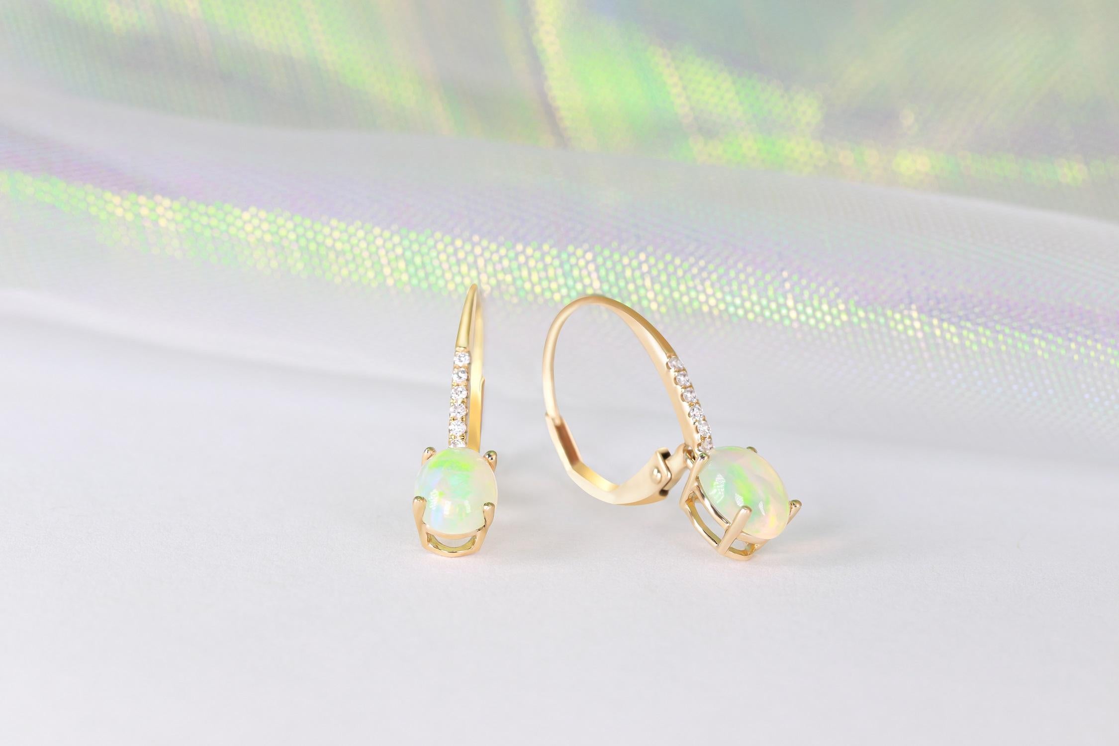 Stunning, timeless and classy eternity Unique Earring. Decorate yourself in luxury with this Gin & Grace Earring. The 14k Yellow Gold jewelry boasts 7x5 Oval Cab Prong Setting Genuine Ethiopian Opal (2 pcs) 1.16 Carat, along with Natural Round cut