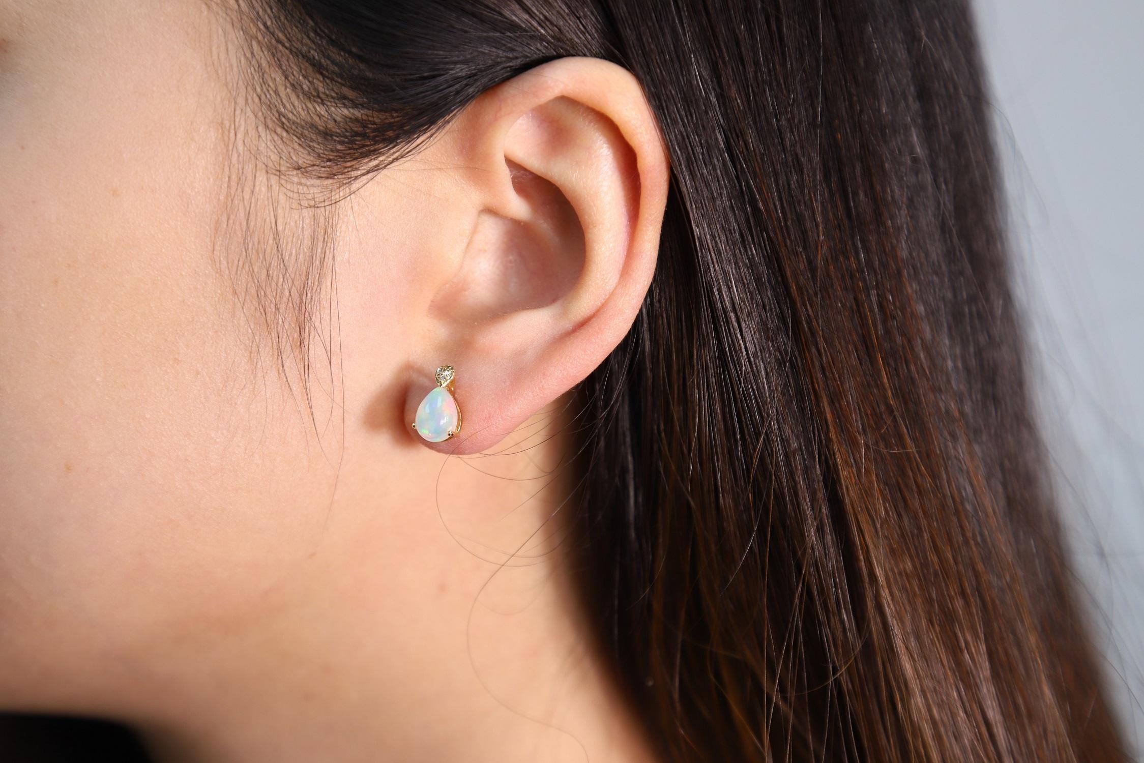 Stunning, timeless and classy eternity Unique Earring. Decorate yourself in luxury with this Gin & Grace Earring. The 10k Yellow Gold jewelry boasts 8x6 Pear Cab Prong Setting Genuine Ethiopian Opal (2 pcs) 1.54 Carat, along with Natural Round cut
