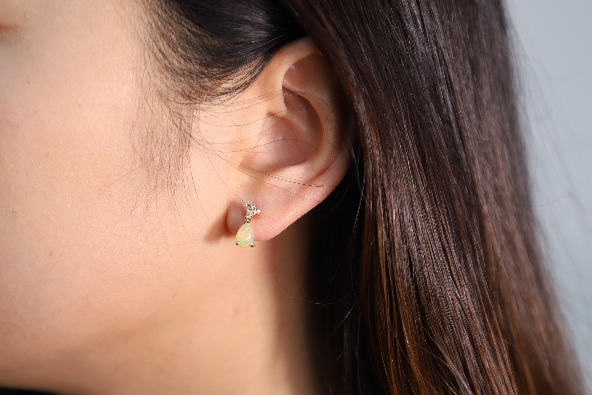Stunning, timeless and classy eternity Unique Earring. Decorate yourself in luxury with this Gin & Grace Earring. The 14k Yellow Gold jewelry boasts 7x5 Pear Cab Prong Setting Genuine Ethiopian Opal (2 pcs) 0.91 Carat, along with Natural Round cut
