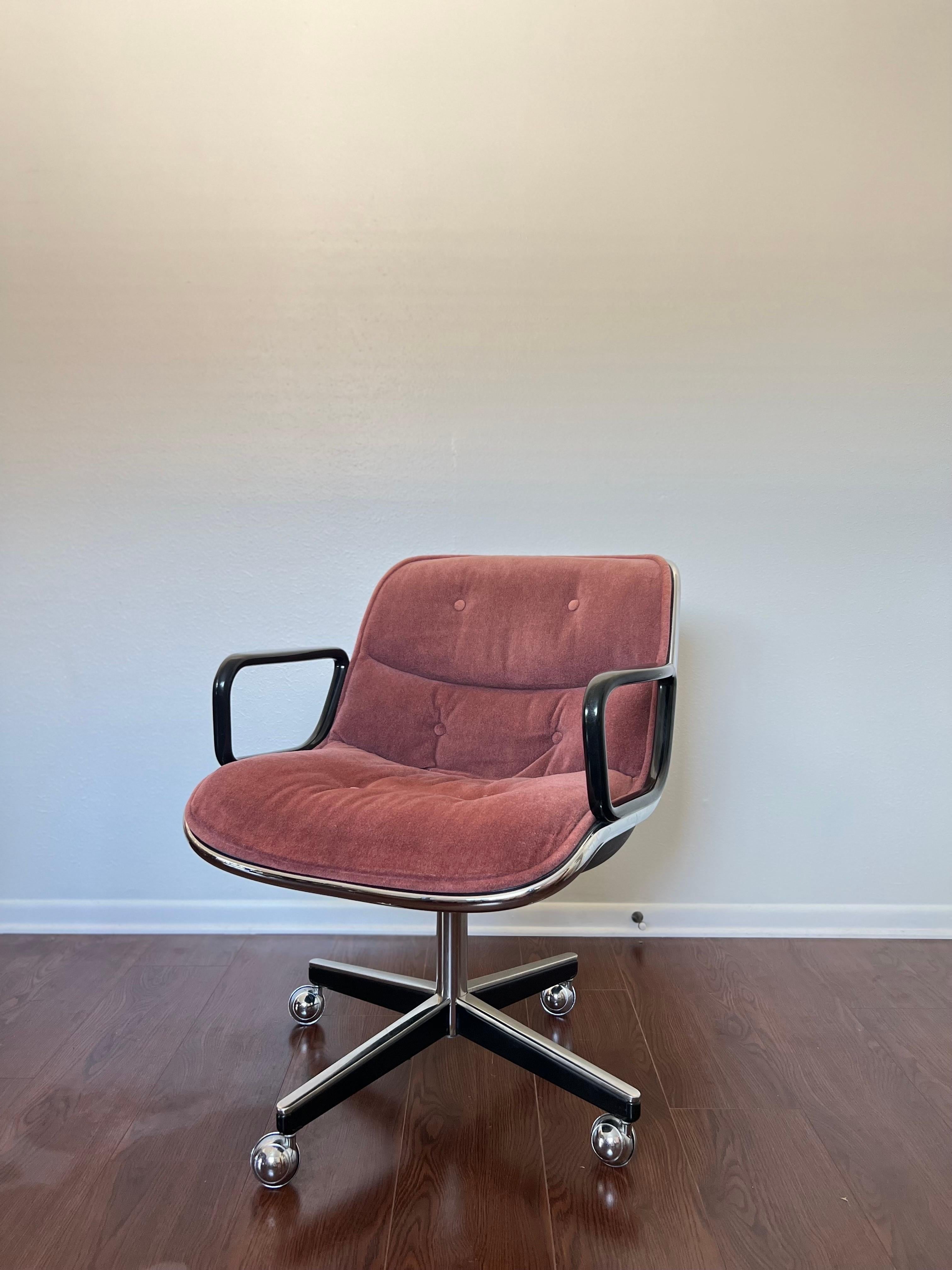 Classic executive chair designed by Charles Pollock for Knoll in 1962, original tags still on the bottom. The upholstery is a pastel pink color, and is in good condition. There are some scratches on the back of the chair as seen in photos. Overall