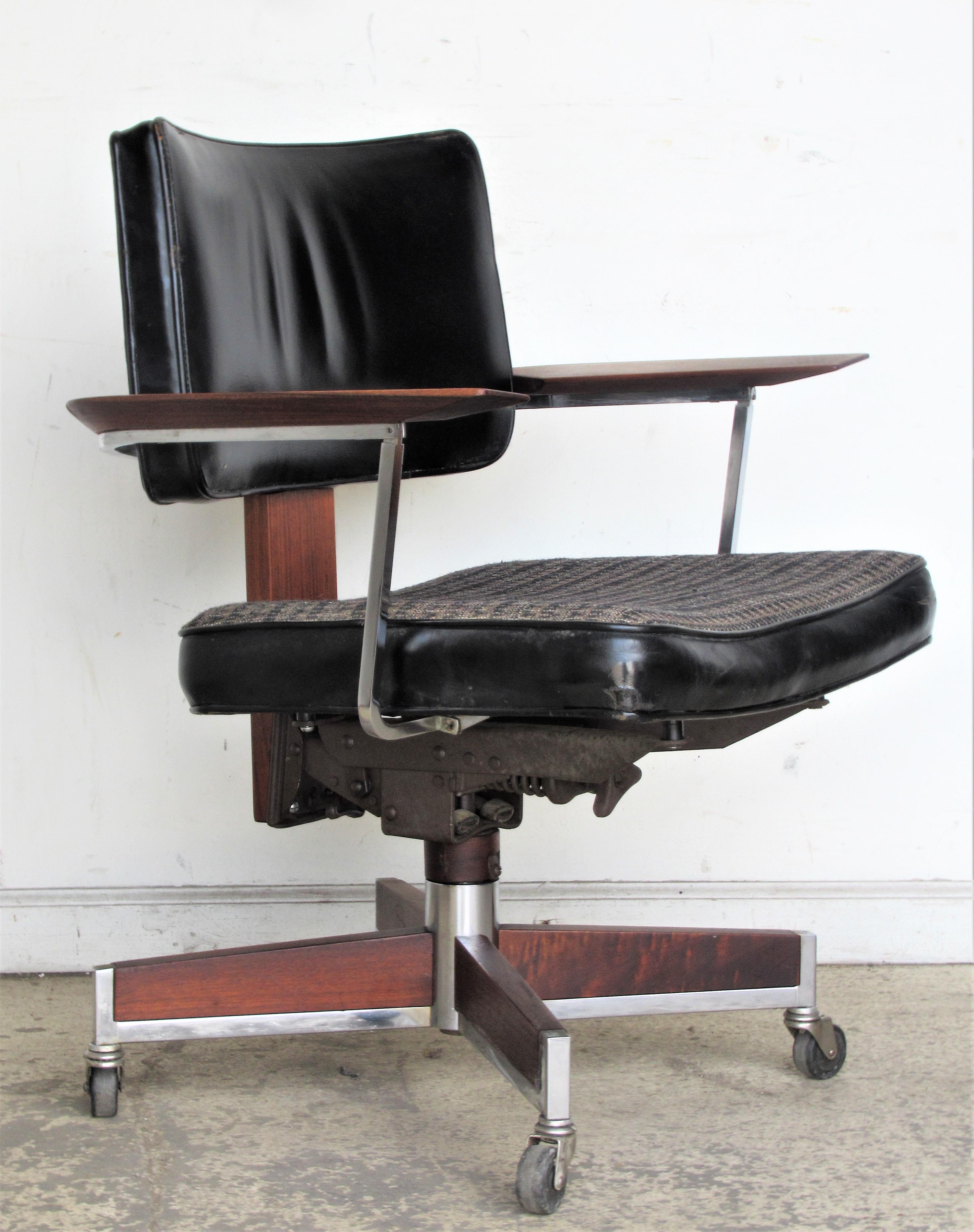 Executive desk chair by Gunlocke in the original walnut / mirror chrome / industrial grade period fabric / black leather. Rolls, swivels, back tilts. Exceptionally fine quality beautifully detailed construction. Great looking and very comfortable,