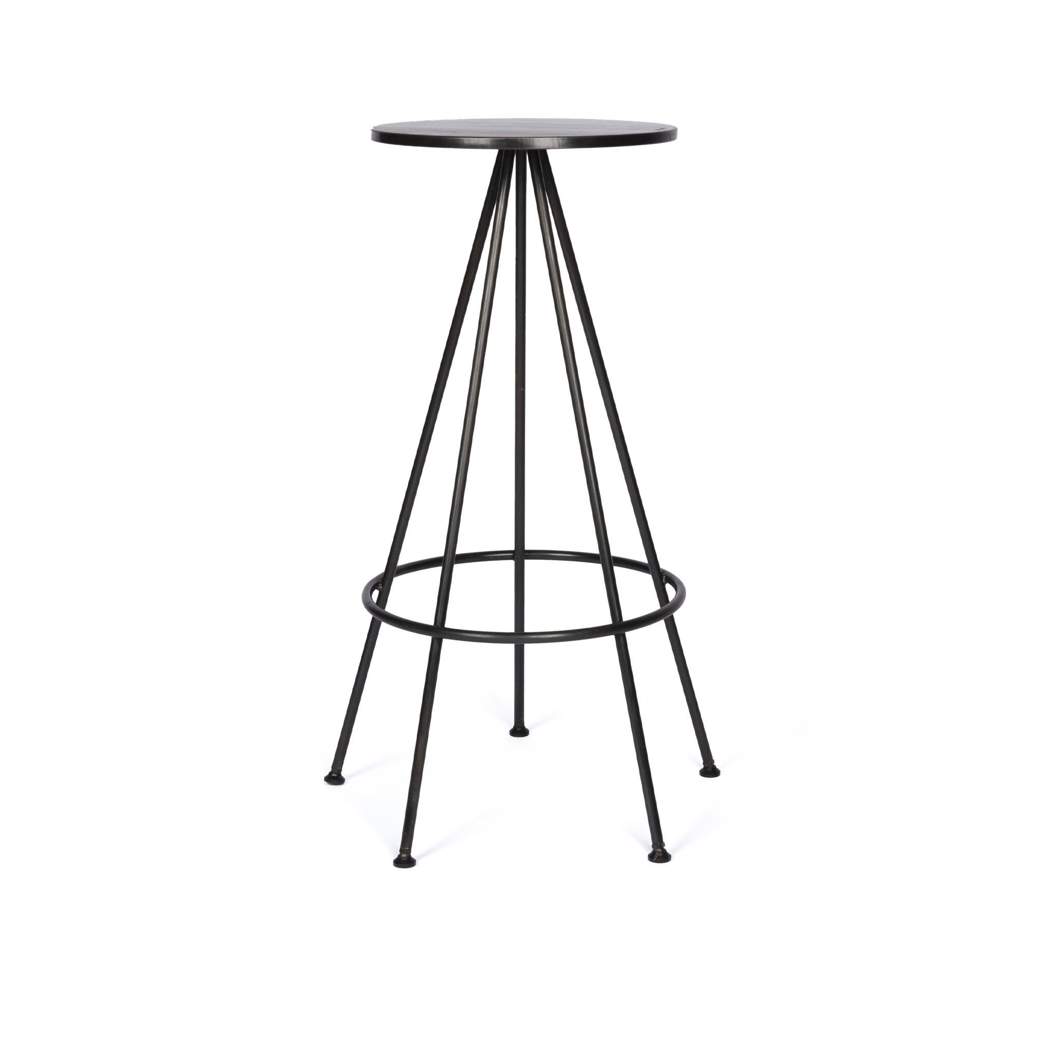This simple urban industrial, sturdy bar stool is composed of five round bar legs and a robust steel seat. It's backless design makes it easy to store under counter tops. Each one is hand crafted and finished in a contemporary blackened finish and