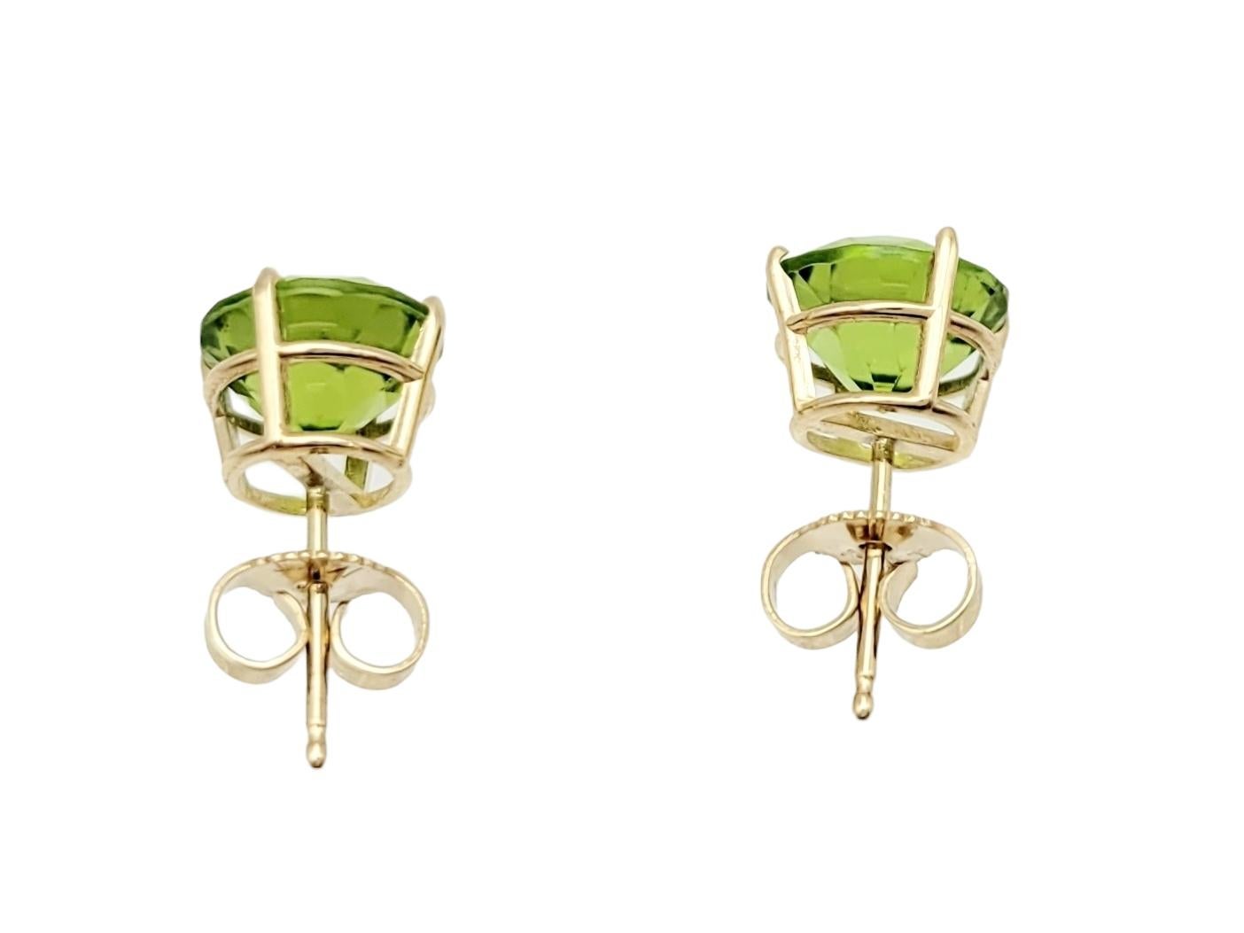 Radiating vibrant allure, these four-prong set peridot stud earrings are a delightful embodiment of timeless simplicity and elegance. Each earring features a brilliant round-cut peridot securely cradled within a classic four-prong setting, allowing