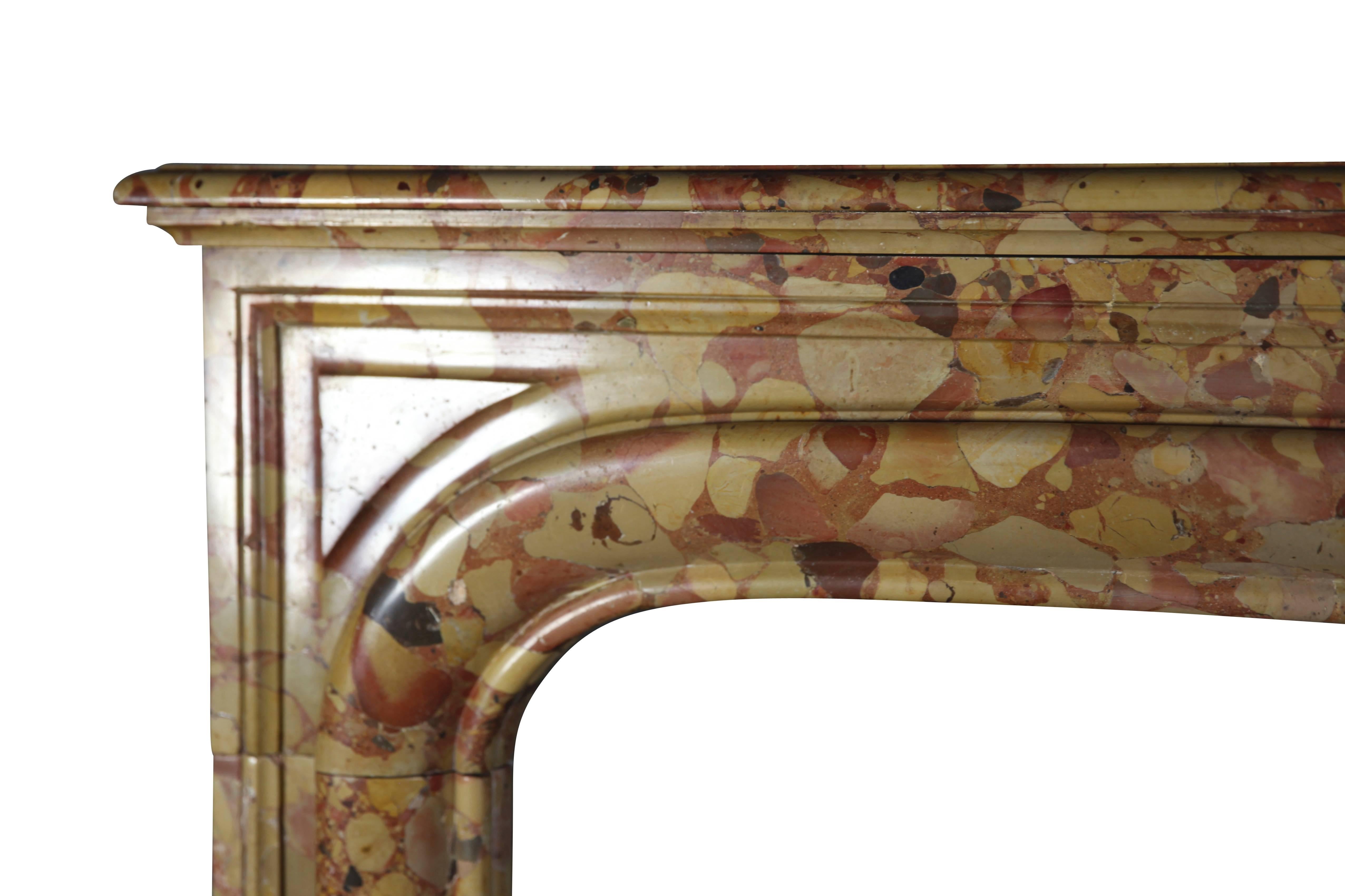 Exclusive antique fireplace surround in the richly colored Royal Breche D’ Aleppo marble. This mantel is in perfect condition. You feel the hand of the maker when you run your fingers across its carvings; and, you see the detail of the work by the