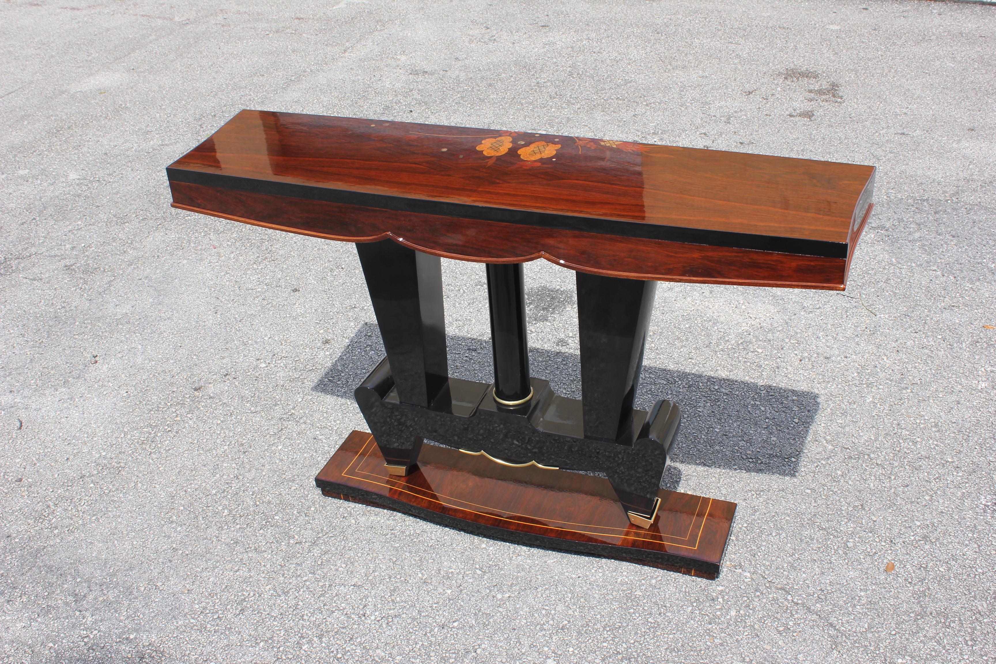 Classic French Art Deco exotic Macassar ebony console tables, circa 1940s. Beautiful parquetry design exotic Macassar ebony top with black lacquer centre base, finish in both side, beautiful bronze hardware detail, that rest on makes it ideal for